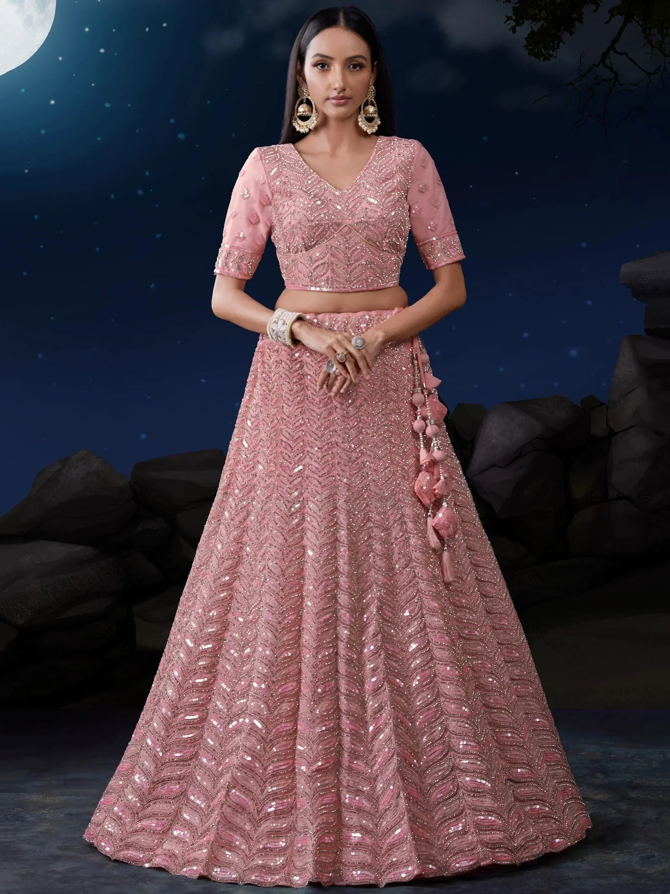 Pink embroidered lehenga choli with sequins, perfect for Indian weddings and festive occasions under moonlight