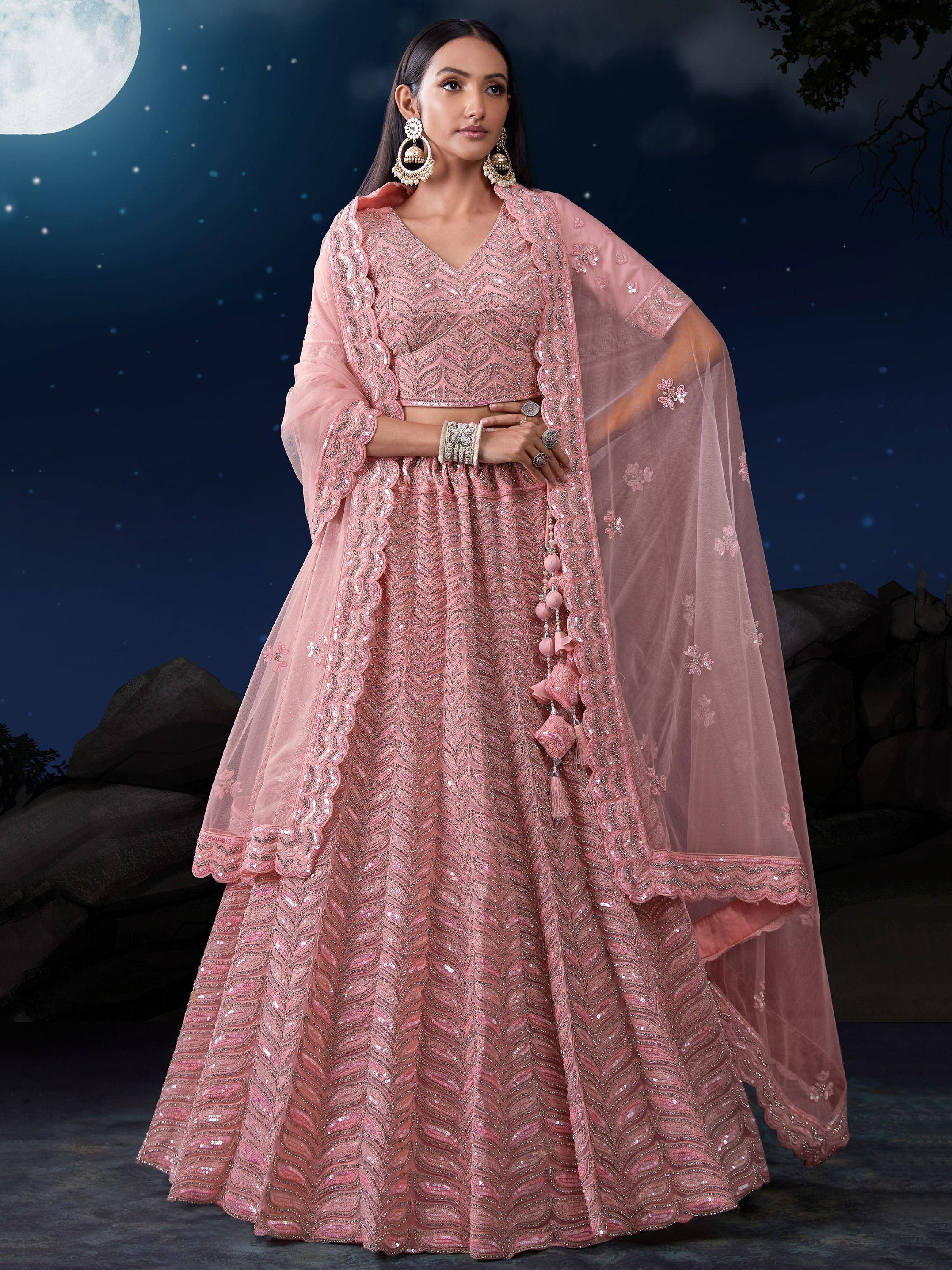 Pink embroidered lehenga choli with dupatta, perfect for Indian weddings and festive occasions under moonlight.
