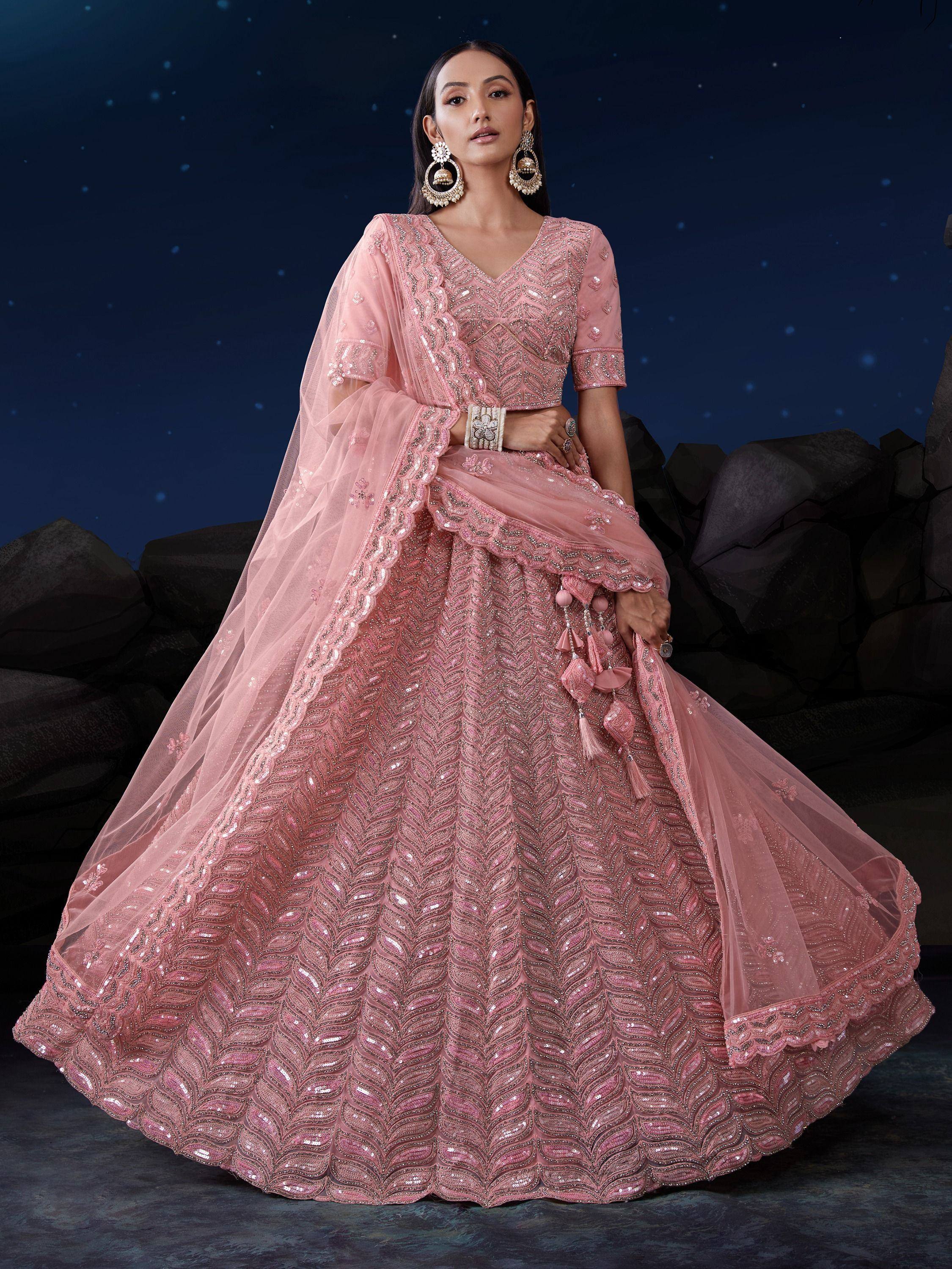 Pink designer lehenga choli with intricate sequin embroidery and matching dupatta, perfect for weddings and festive occasions.
