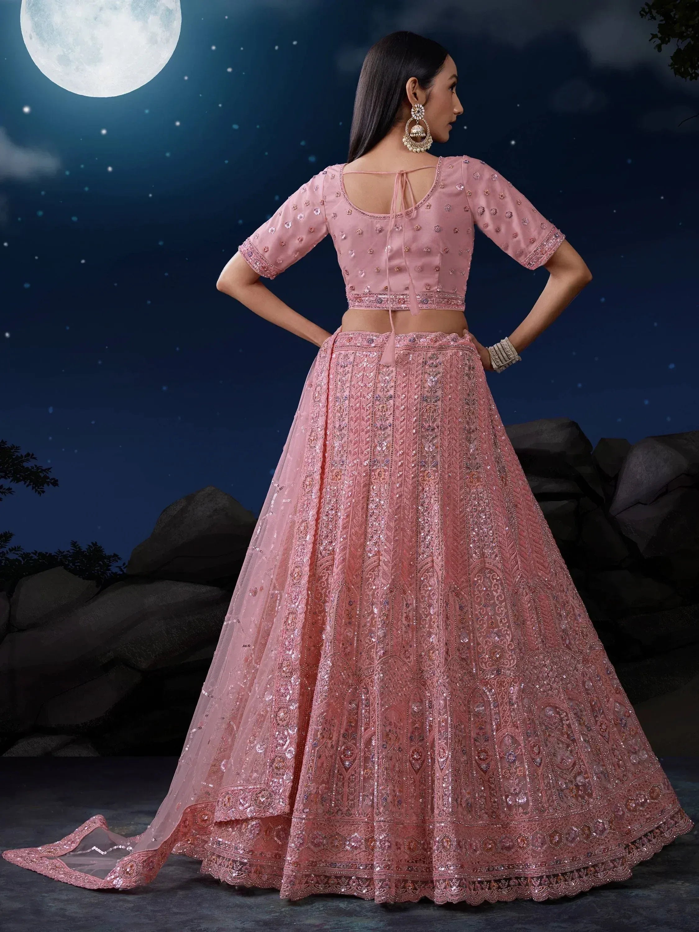 Pink embroidered lehenga choli with sequins under full moon, ethnic Indian wear for weddings