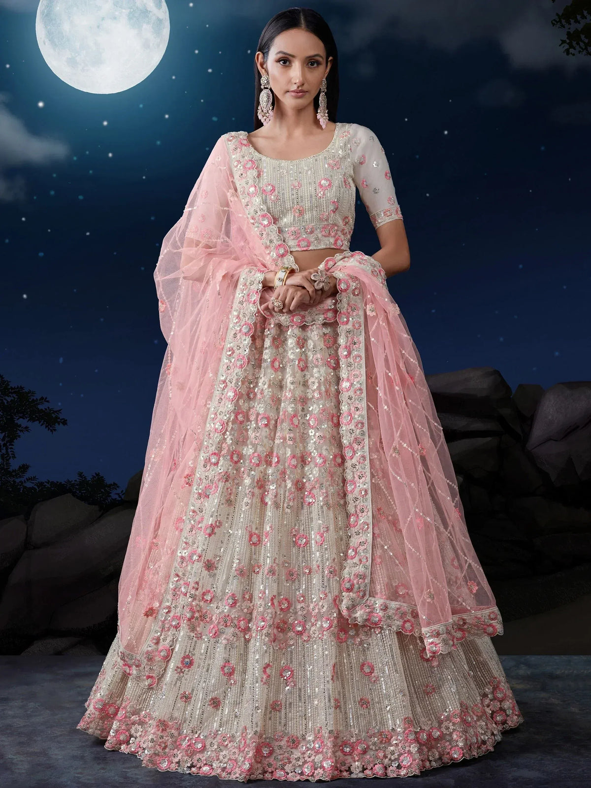 Pink and ivory floral embroidered lehenga choli with net dupatta, perfect for weddings and festive occasions.