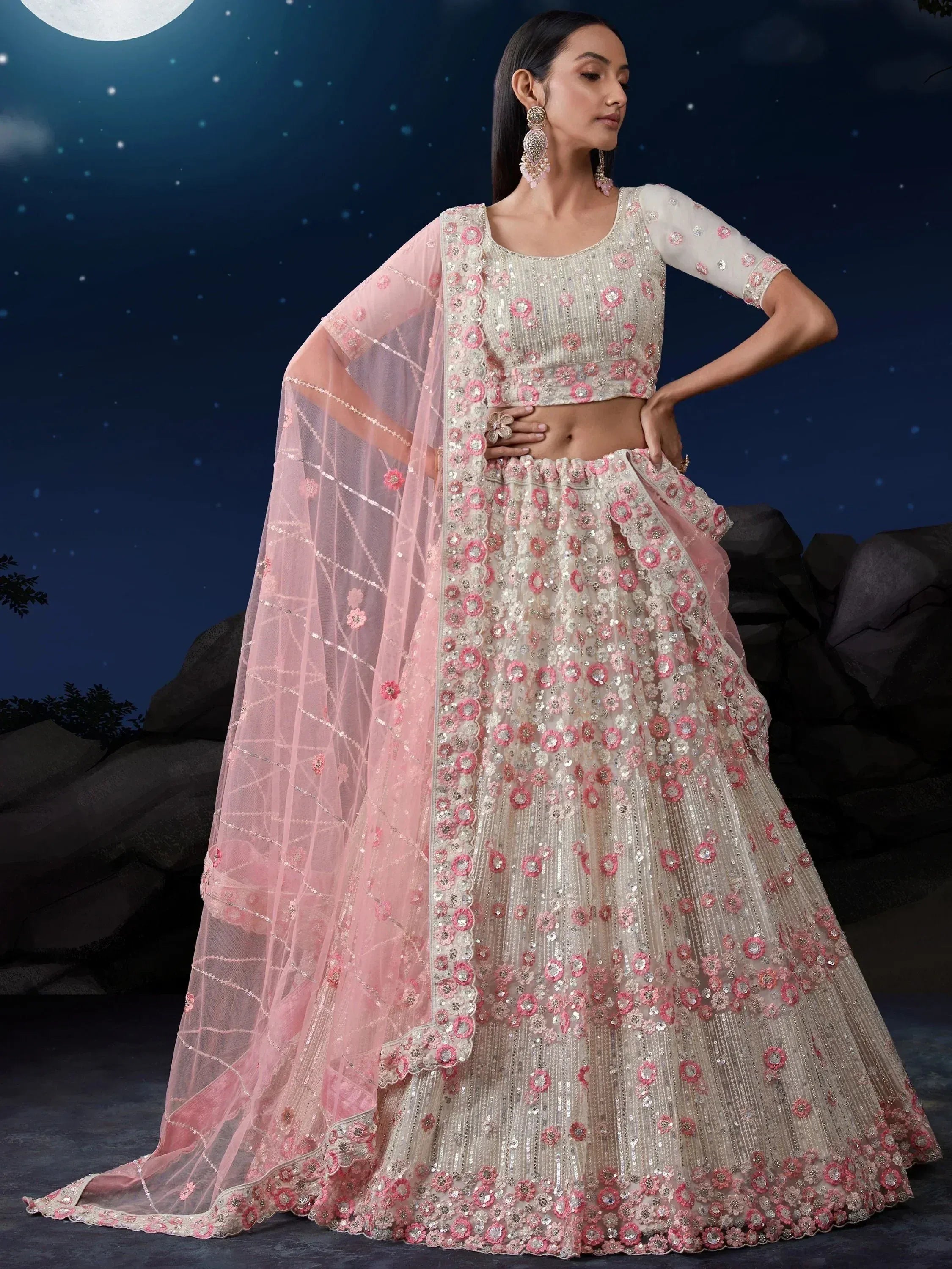Elegant ivory and pink floral embroidered lehenga choli with sheer dupatta, perfect for Indian weddings and festive occasions.