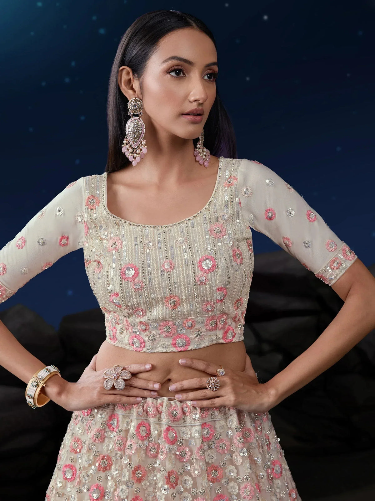 Elegant ivory lehenga choli with pink floral embroidery and sequins, perfect for Indian ethnic wear.