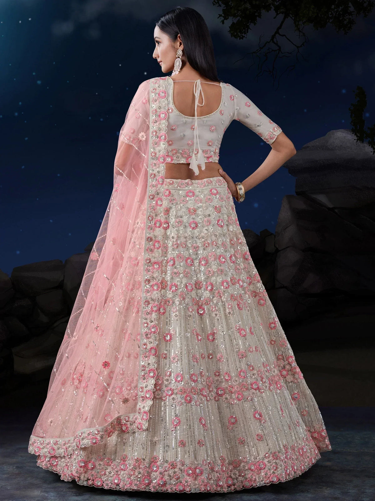 Elegant ivory and pink floral embroidered lehenga choli with sheer dupatta, perfect for Indian weddings and festive occasions.