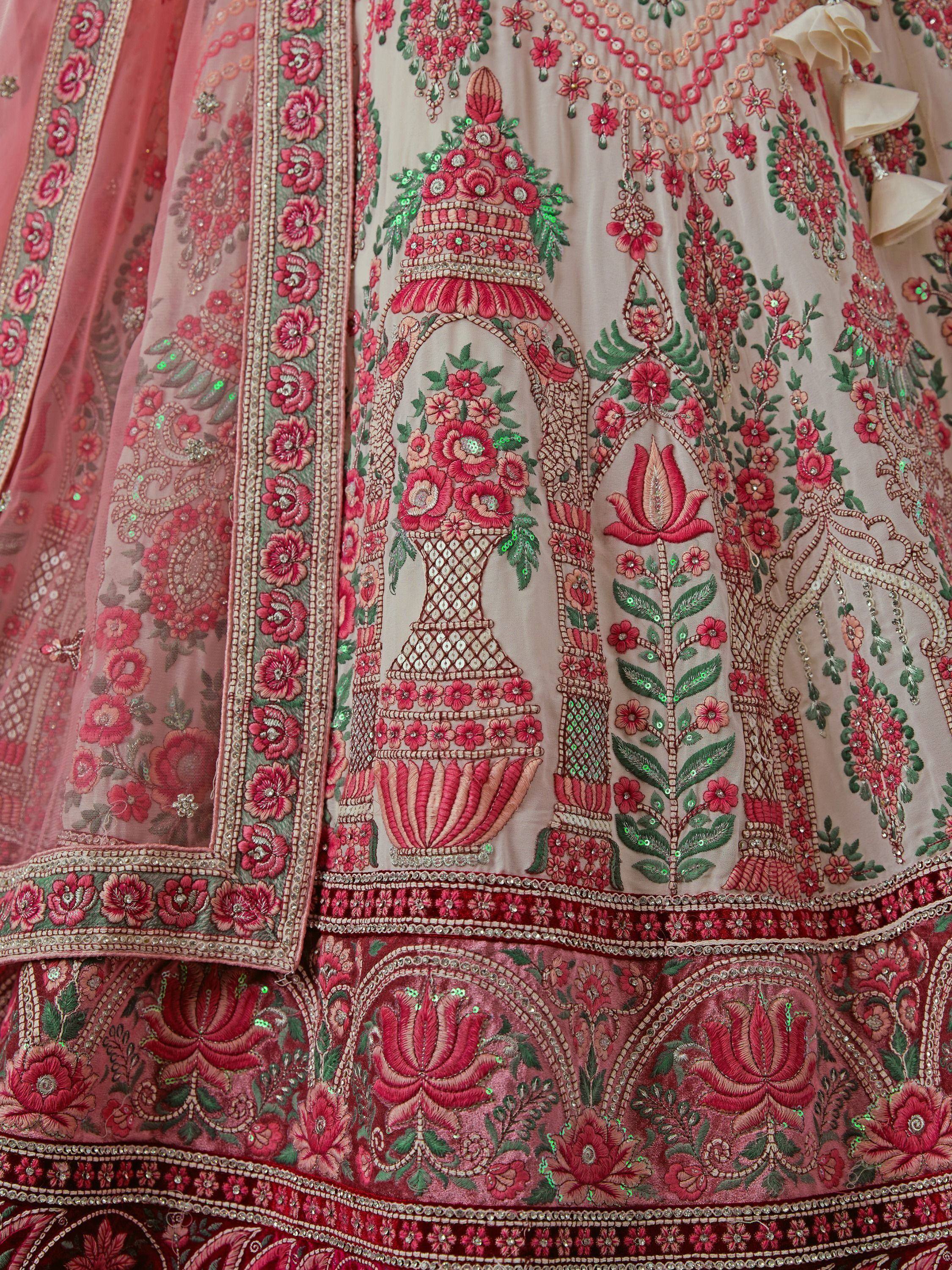 Pink and green floral embroidered lehenga choli with intricate mirror work and sequins