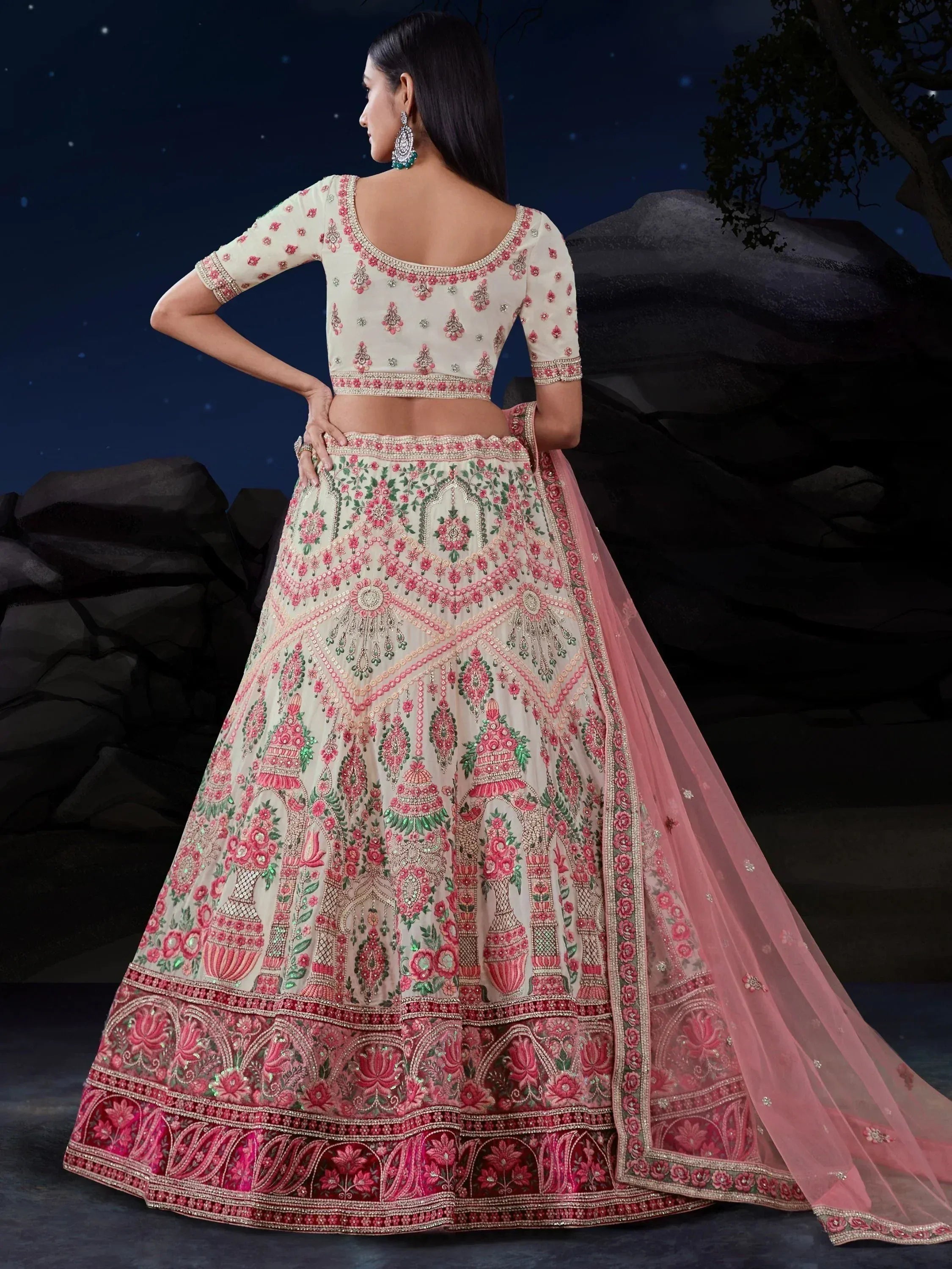 Elegant ivory and pink embroidered lehenga choli with floral motifs, perfect for Indian weddings and festive occasions.