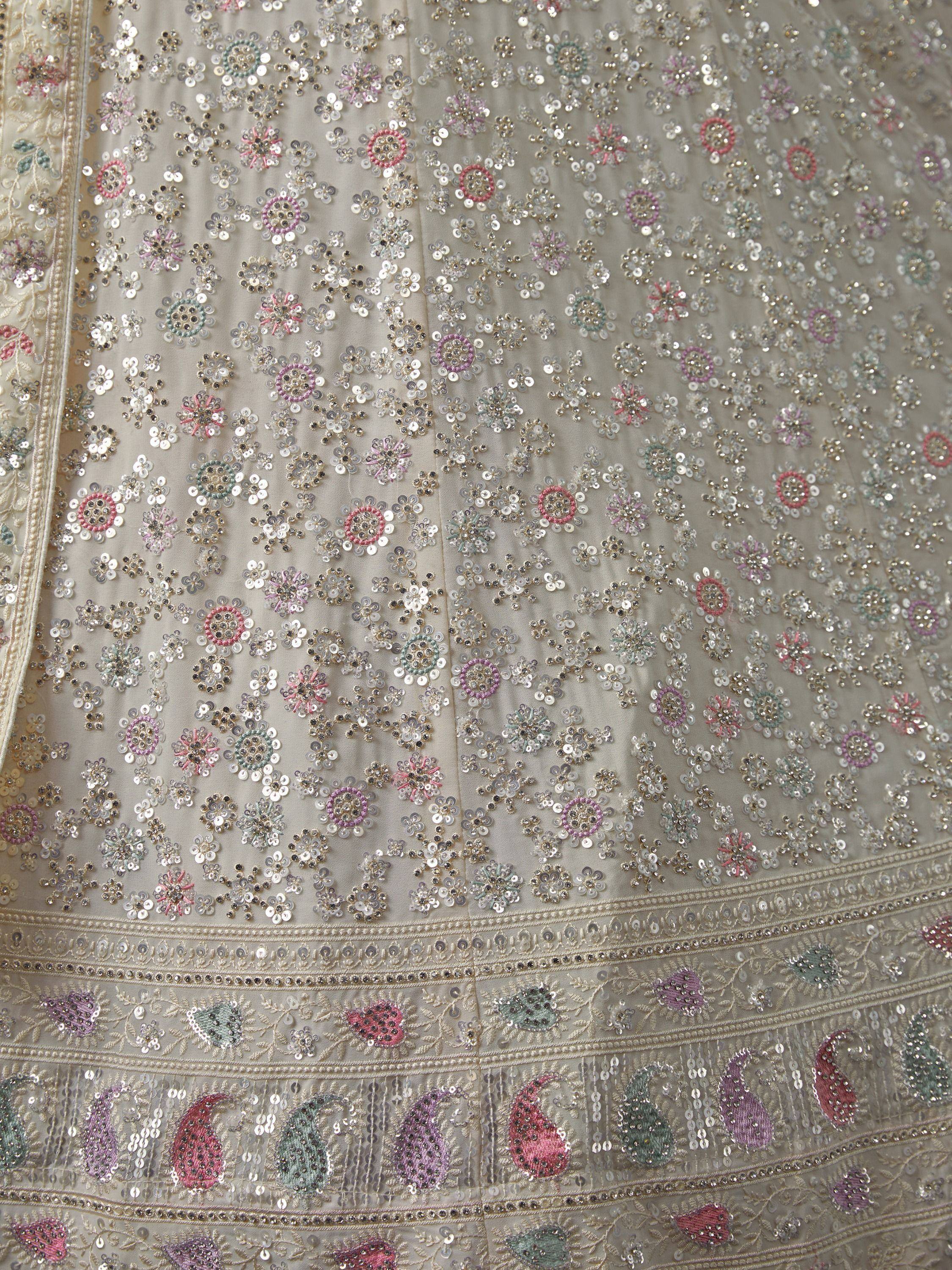 Elegant Indian ethnic wear with intricate floral sequin embroidery and colorful paisley details on soft fabric.