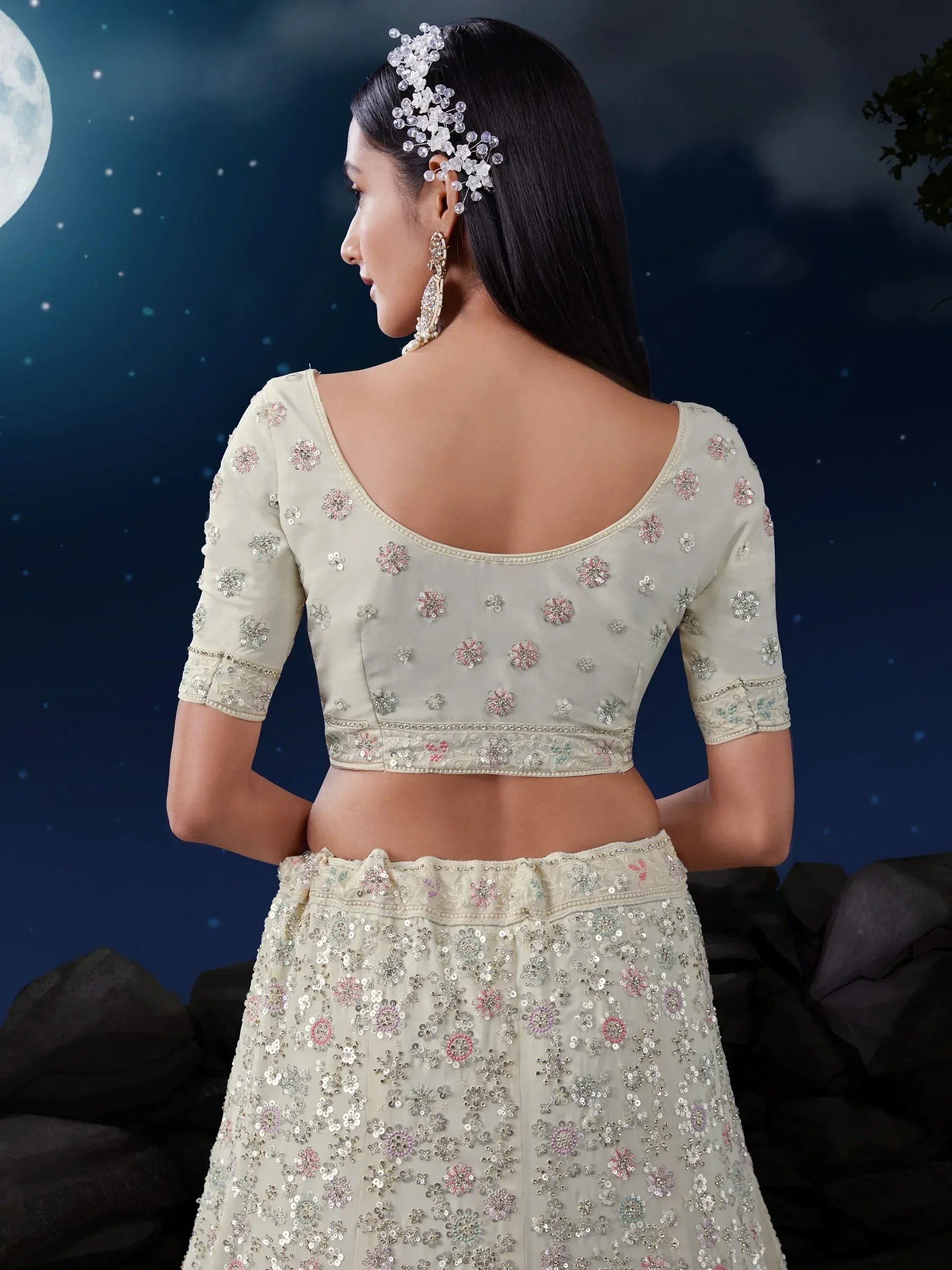 Elegant ivory lehenga choli with floral sequin embroidery, perfect for Indian ethnic wear occasions.