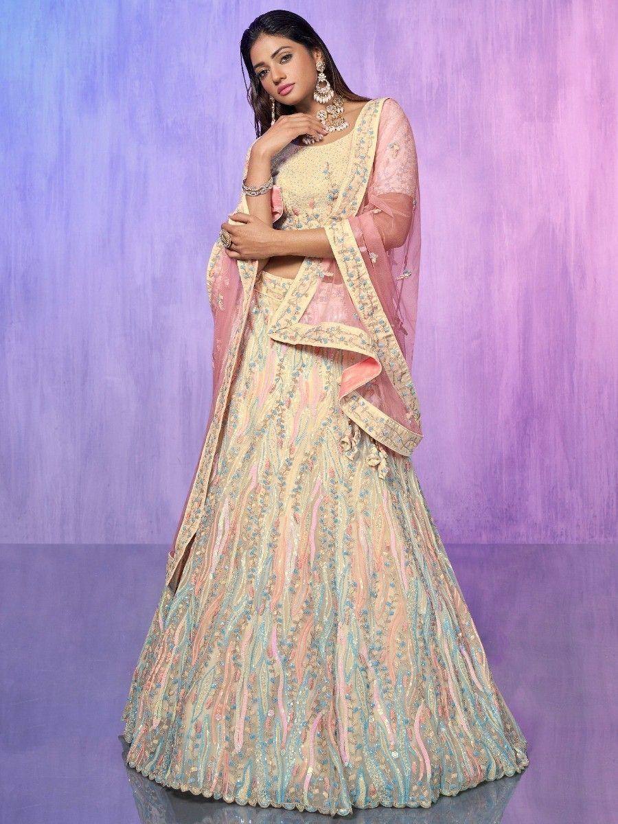Elegant pastel lehenga choli with intricate embroidery and sheer dupatta, perfect for Indian weddings and festive occasions.