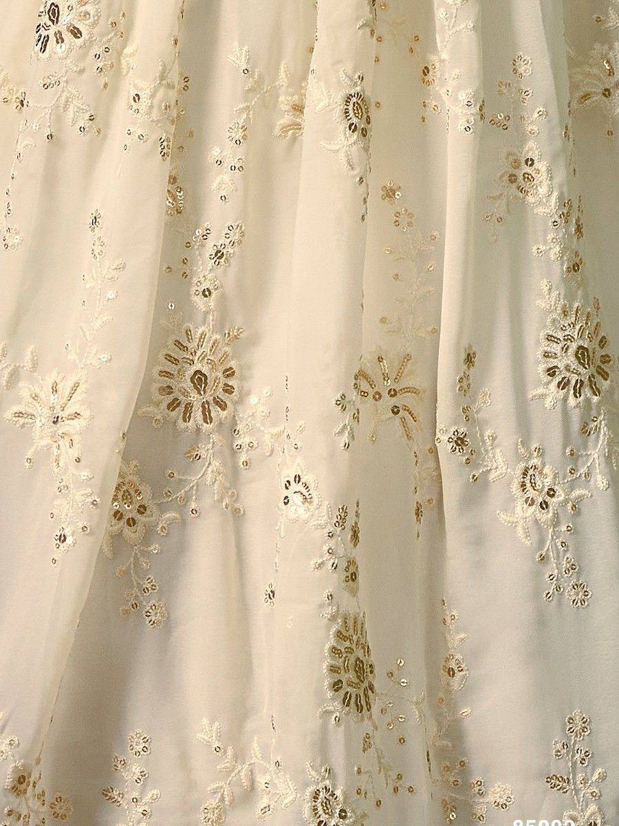 Cream ethnic gown with gold floral embroidery and sequin detailing for festive occasions