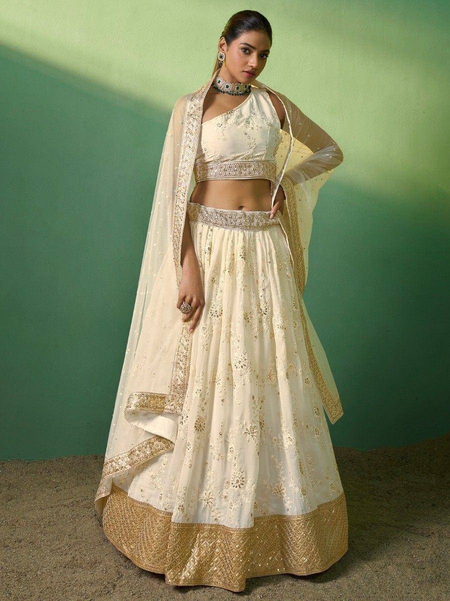 Cream and gold embroidered lehenga choli with sheer dupatta, perfect for Indian ethnic occasions