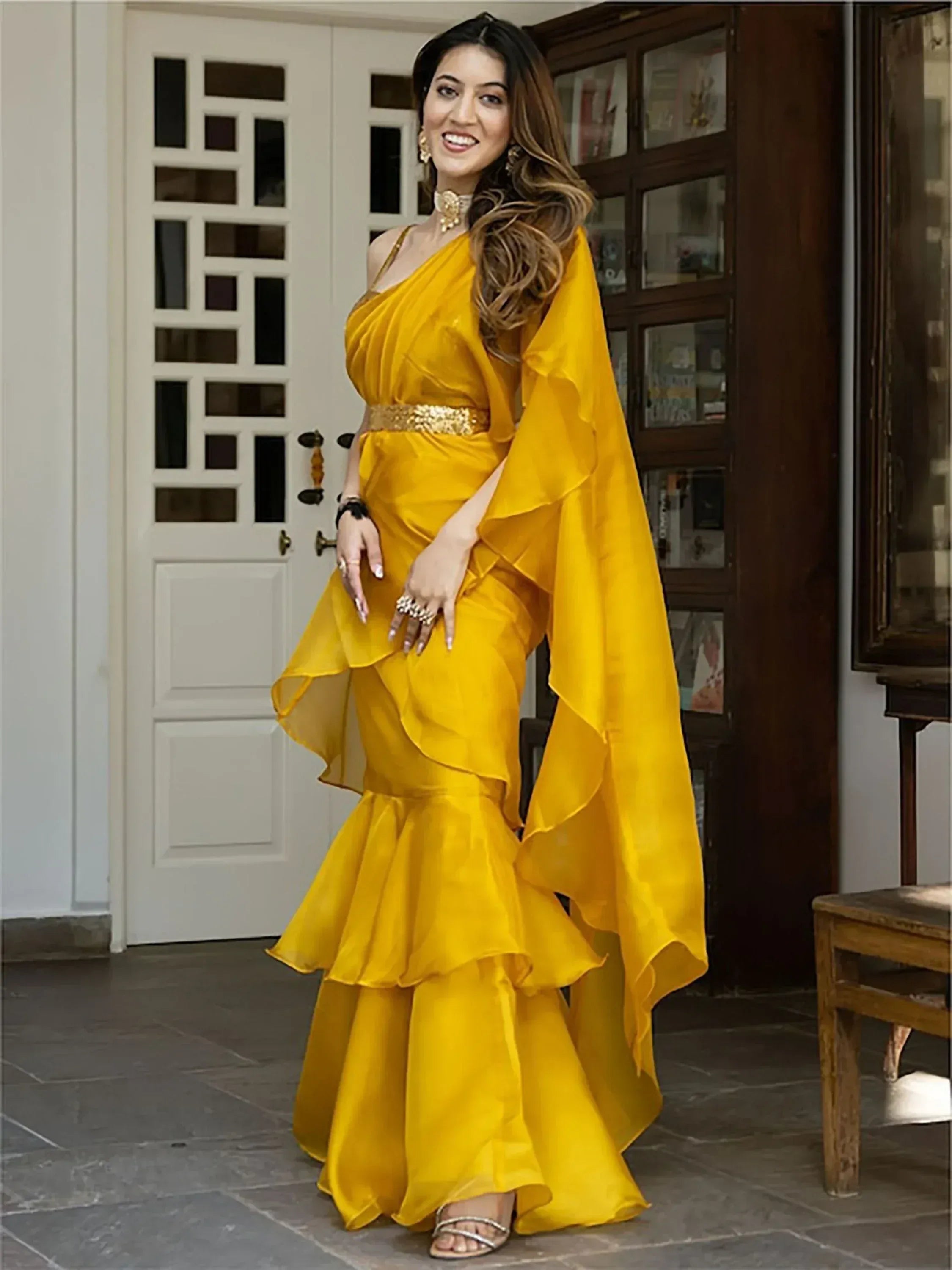 Yellow ruffle ethnic gown with gold belt, perfect for Indian weddings and festive occasions