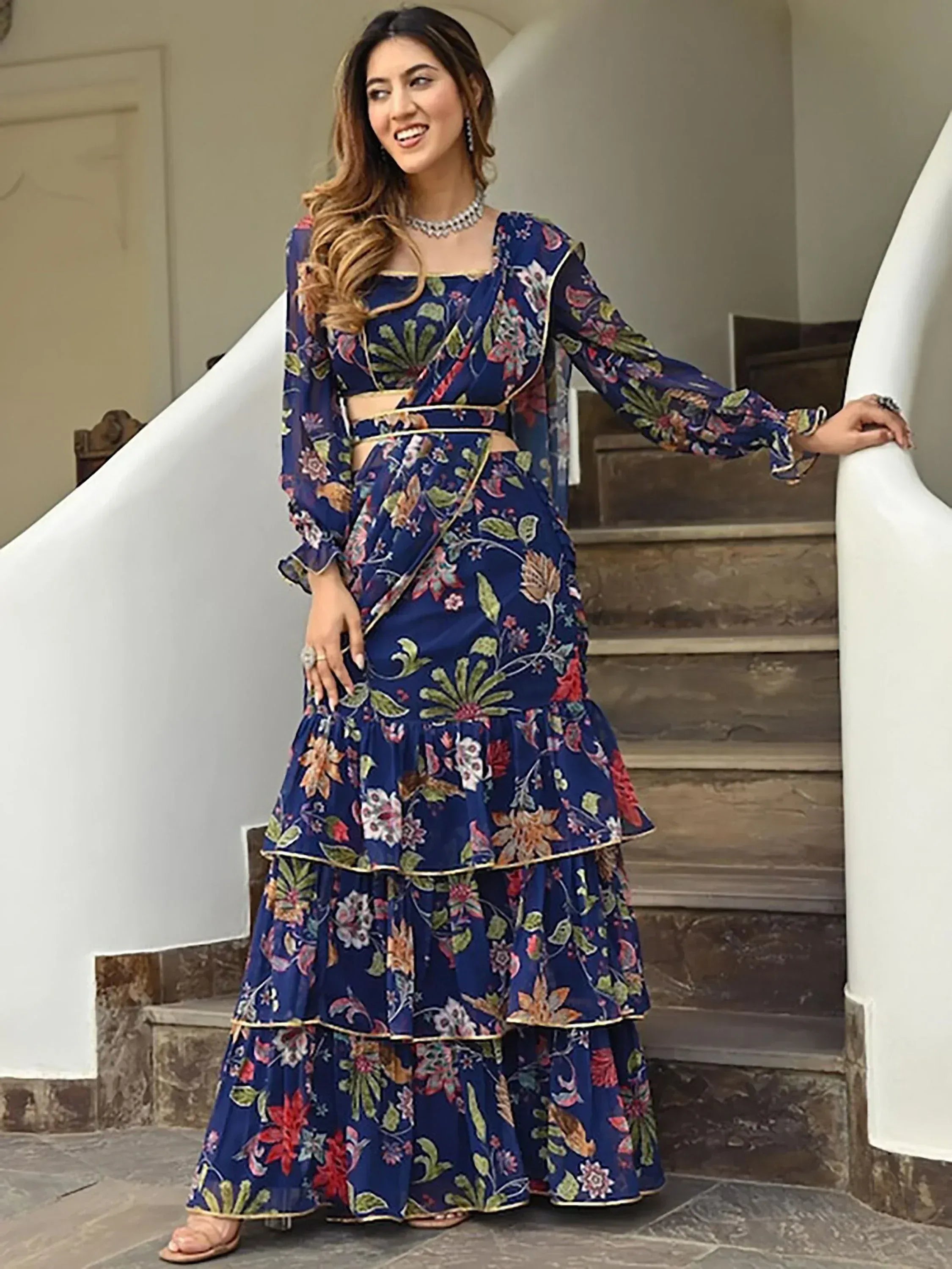 Woman in blue floral printed lehenga choli with ruffled layers, perfect for Indian ethnic occasions