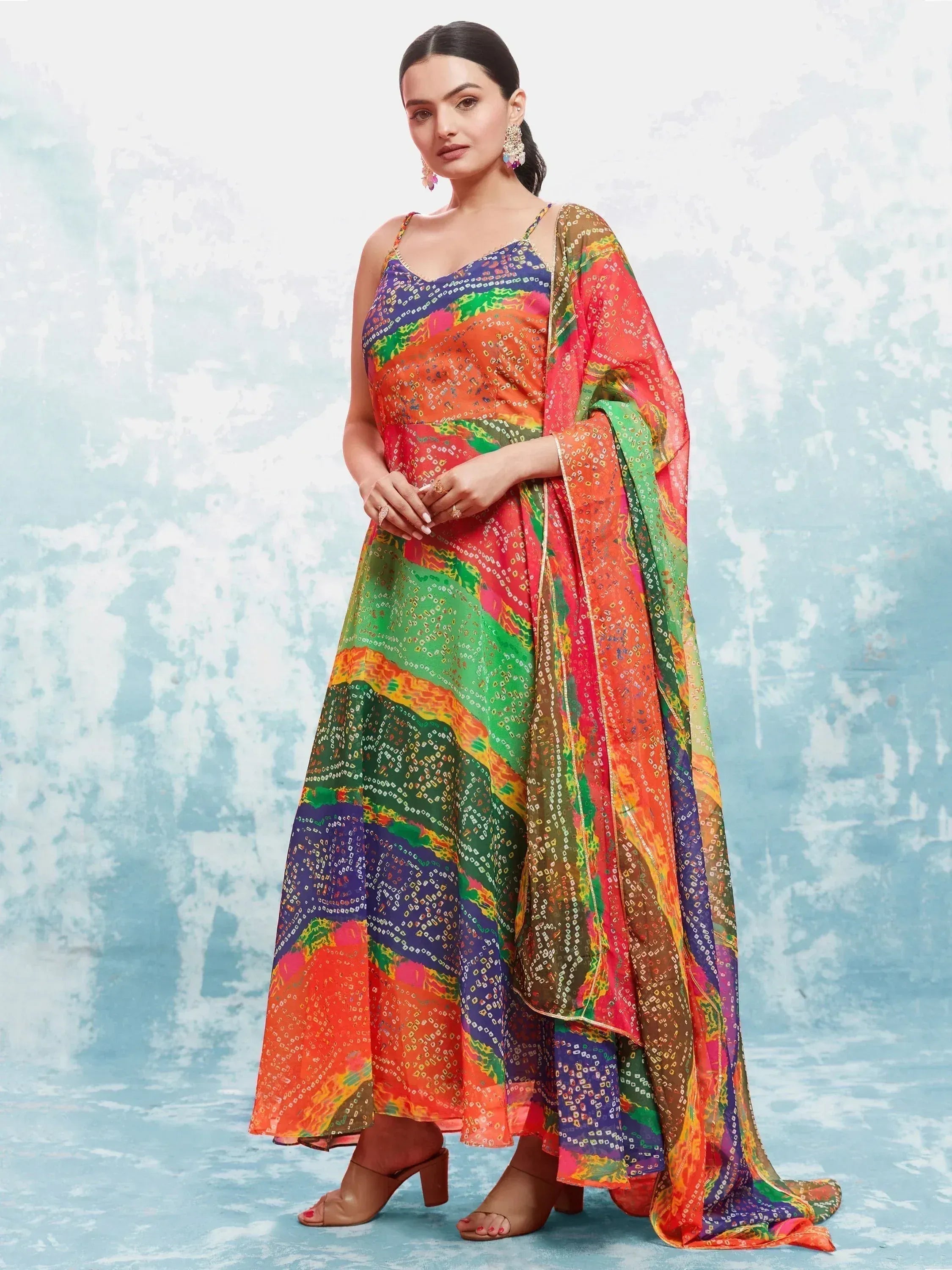 Woman in multicolor bandhani print ethnic gown with matching dupatta, festive wear