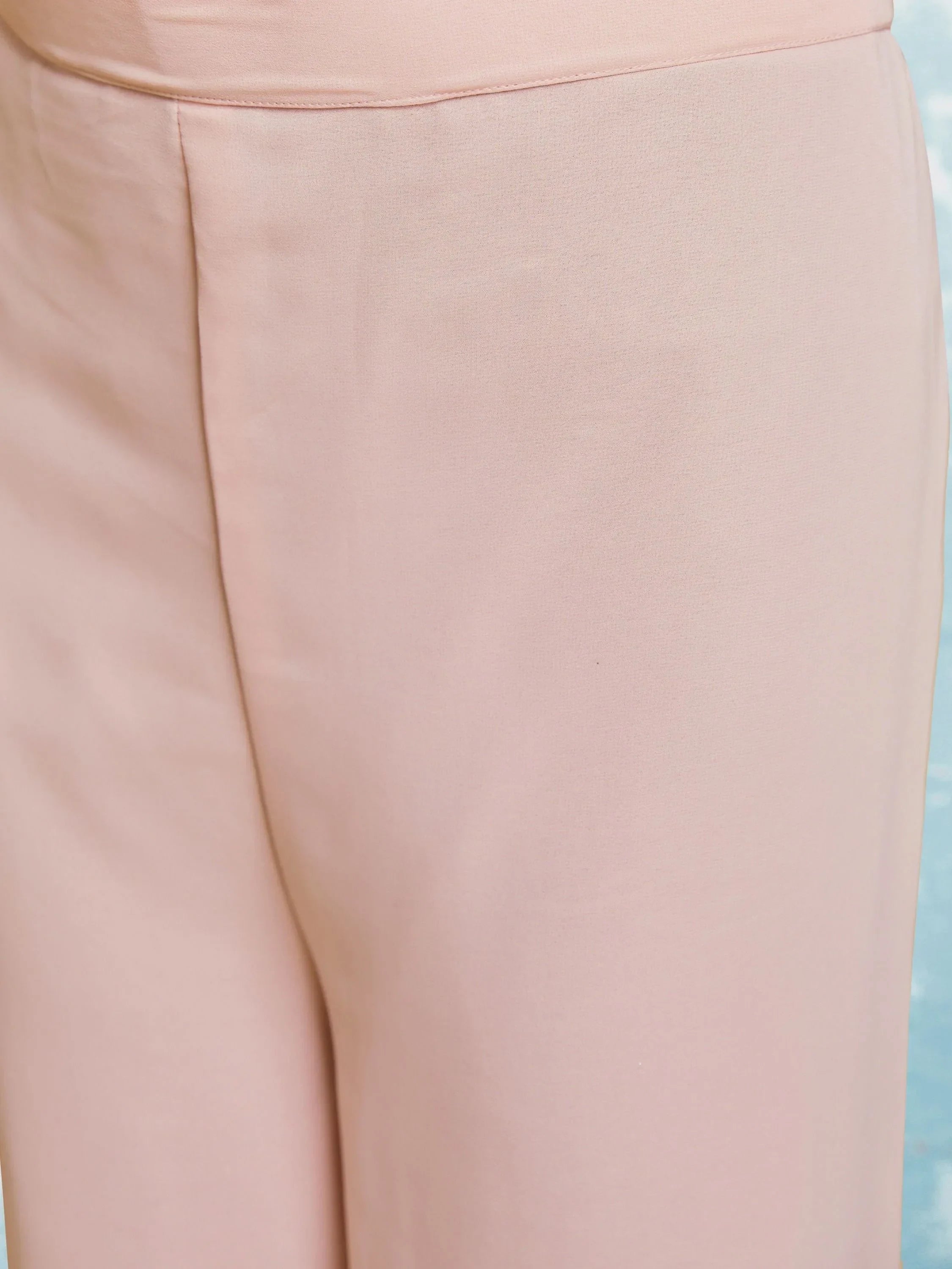 Close-up of light pink straight pants with clean stitching, Indian ethnic wear.