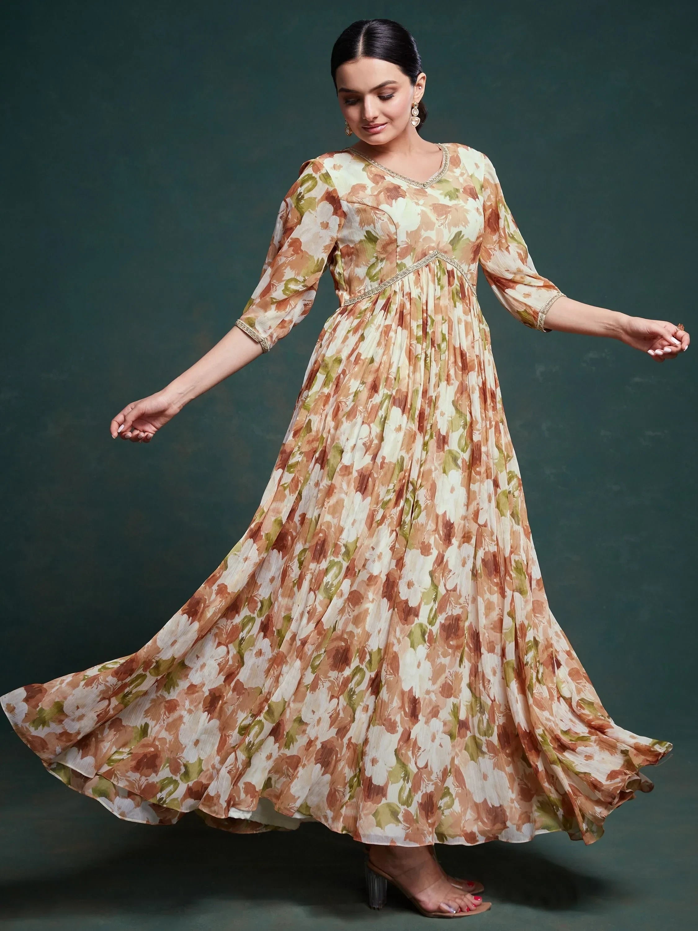 Woman in a floral printed ethnic gown with three-quarter sleeves, elegant festive wear