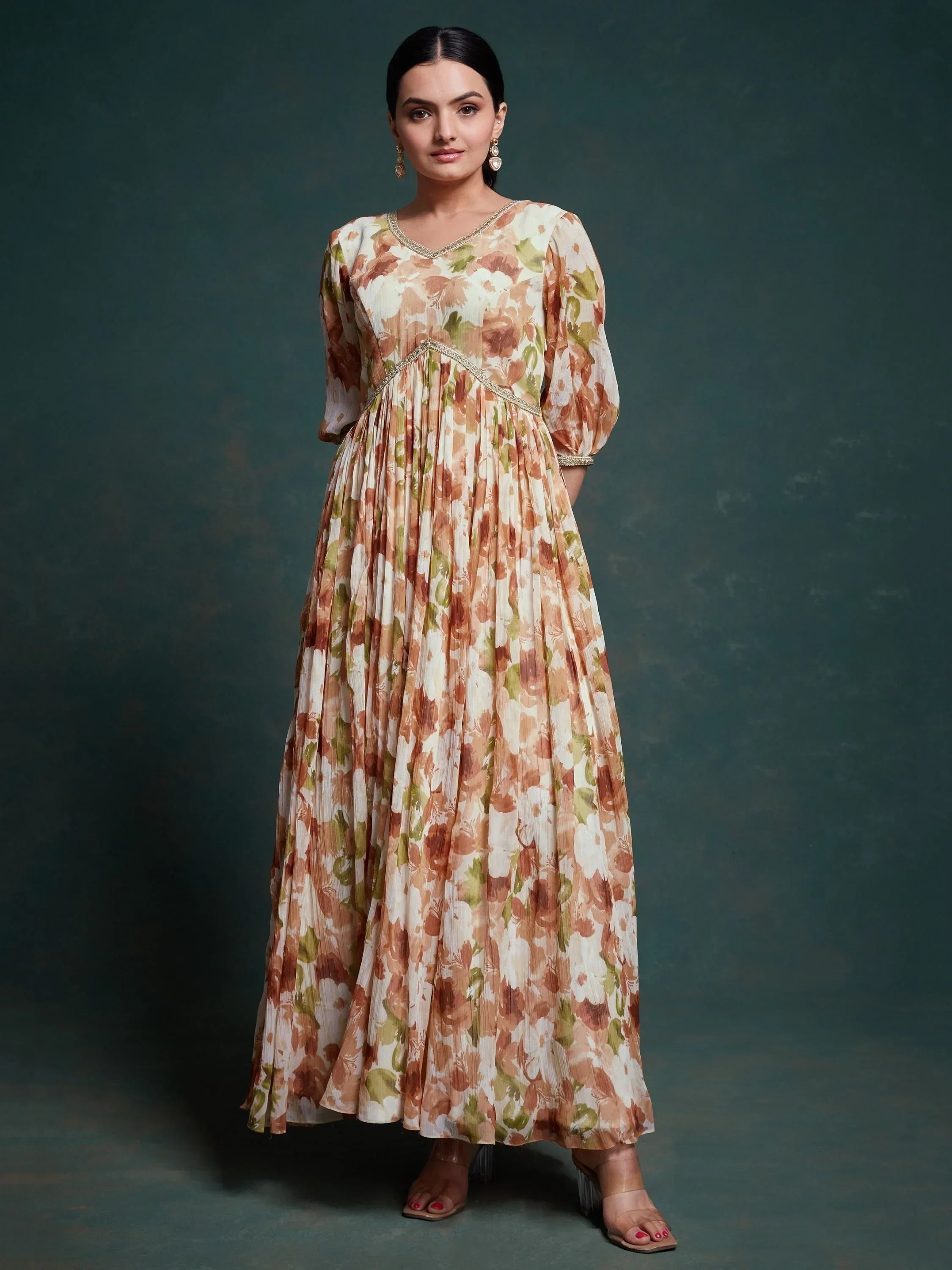 Woman wearing a floral print ethnic gown with puff sleeves and pleated skirt
