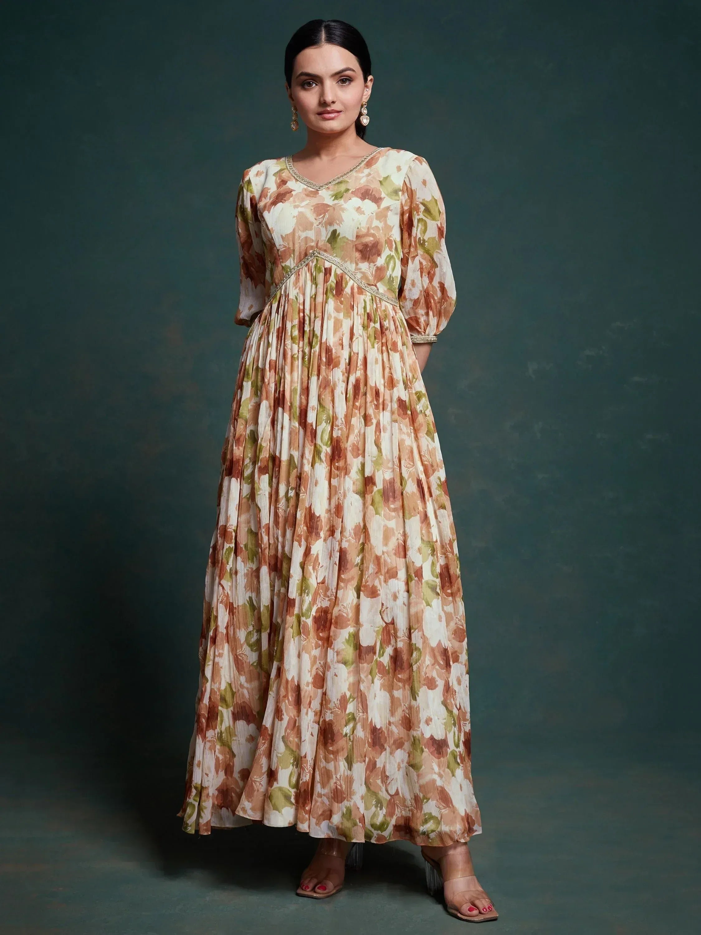 Floral print ethnic gown with pleated skirt and embellished neckline, perfect for Indian occasions