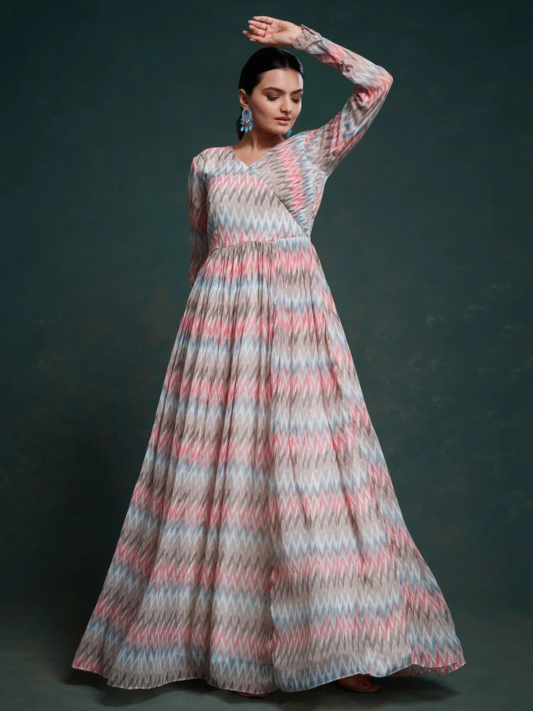 Woman wearing a pastel zigzag patterned long ethnic gown with long sleeves and V-neck