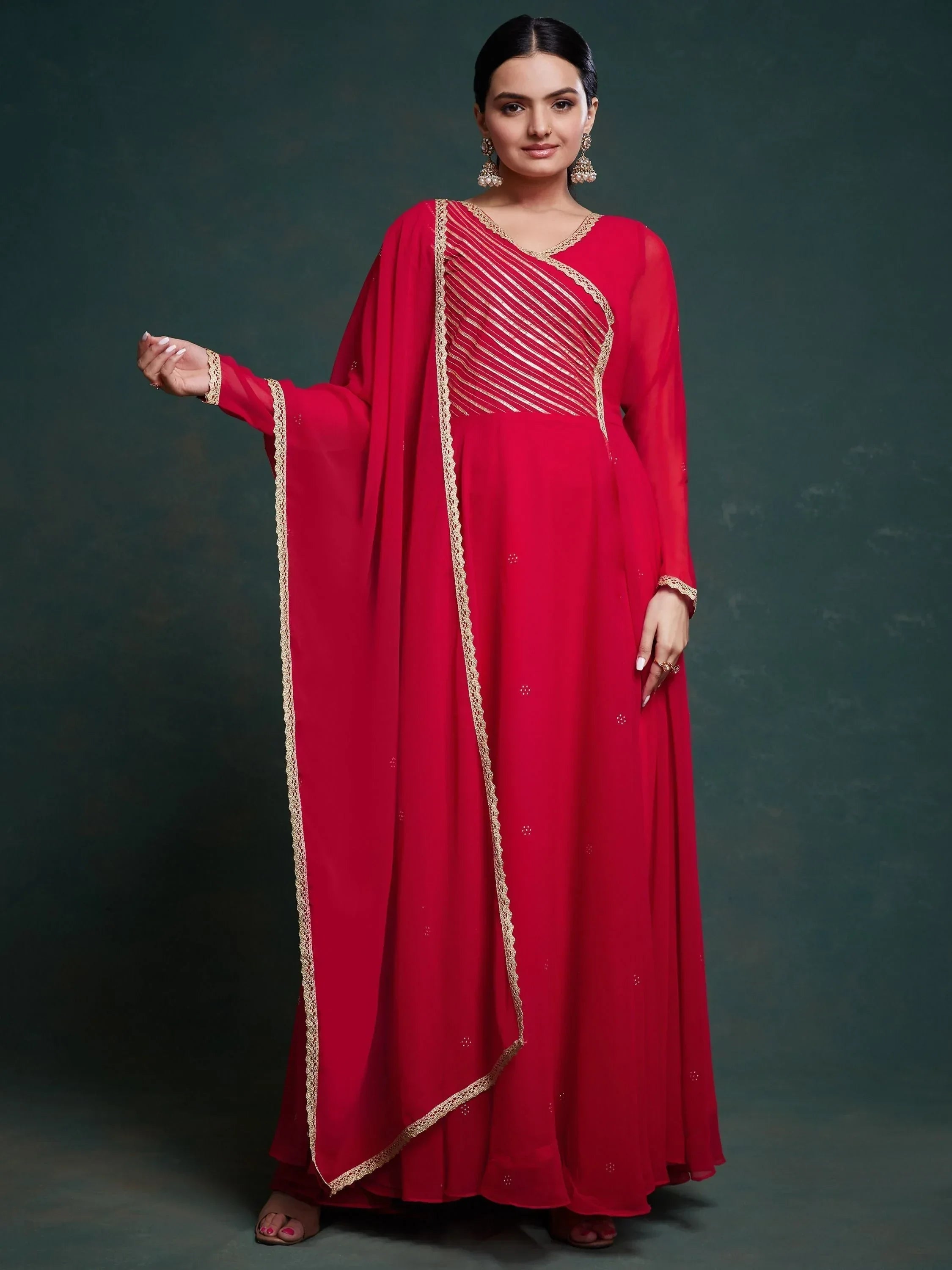 Woman wearing red embroidered Anarkali suit with gold accents and matching dupatta