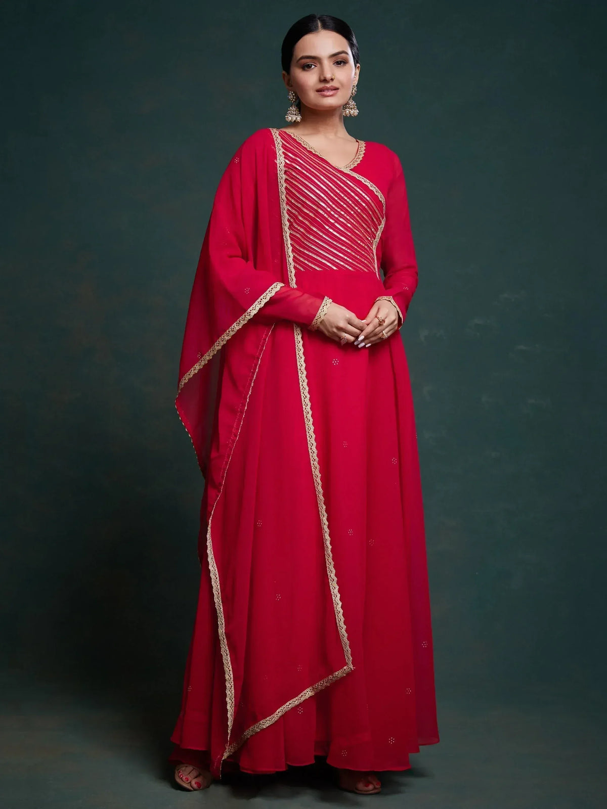 Red ethnic gown with gold embroidery, perfect for Indian weddings and festive occasions