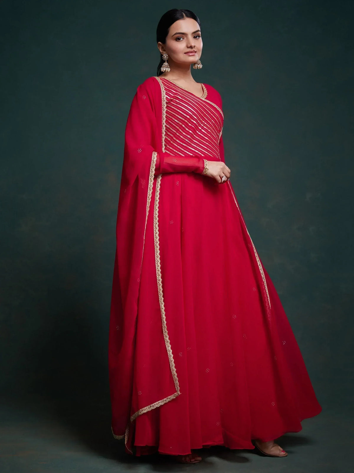 Red ethnic gown with gold embroidery, perfect for Indian weddings and festive occasions