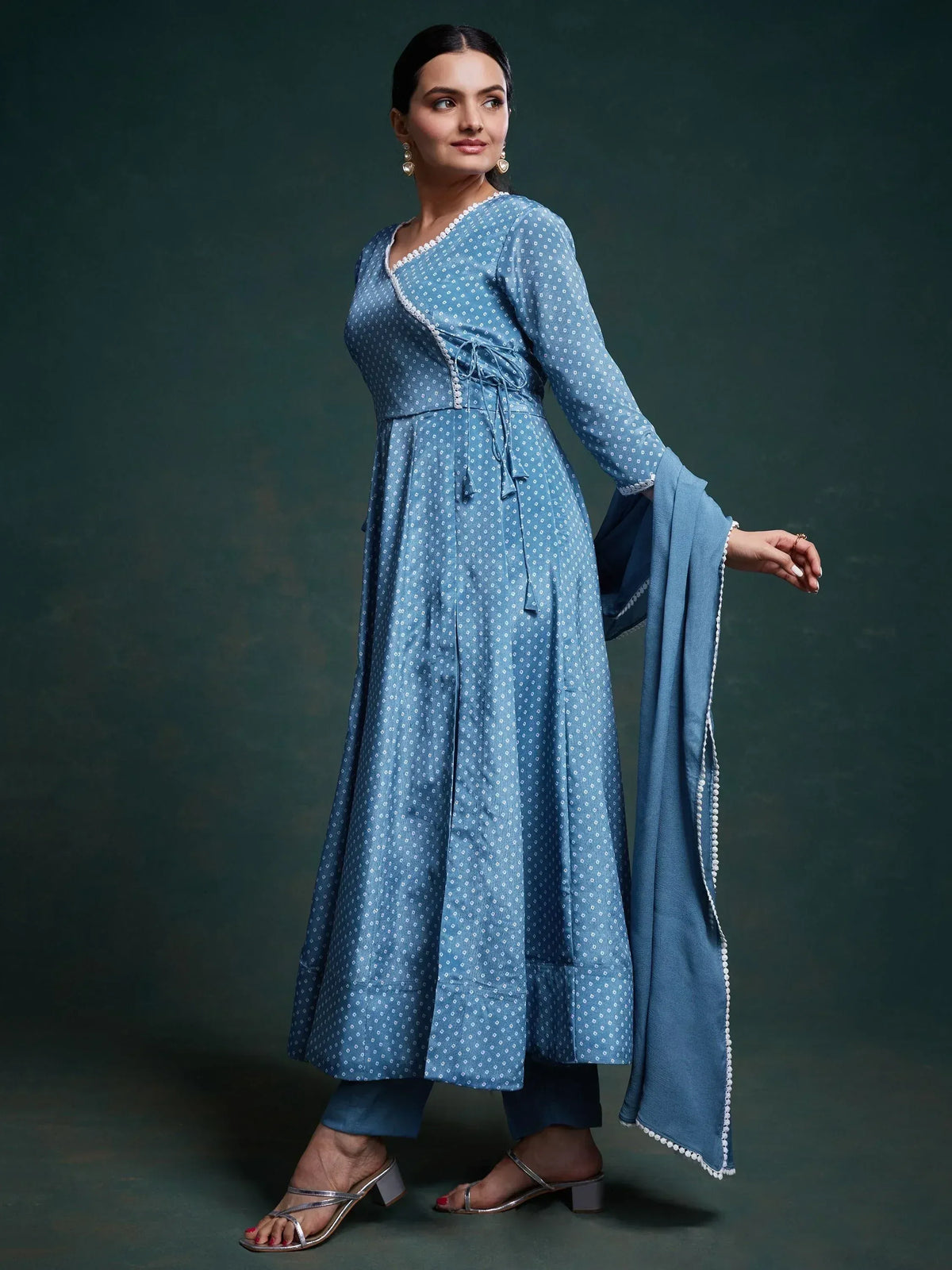 Blue printed anarkali suit with white pom-pom trim, paired with matching dupatta and pants for ethnic wear