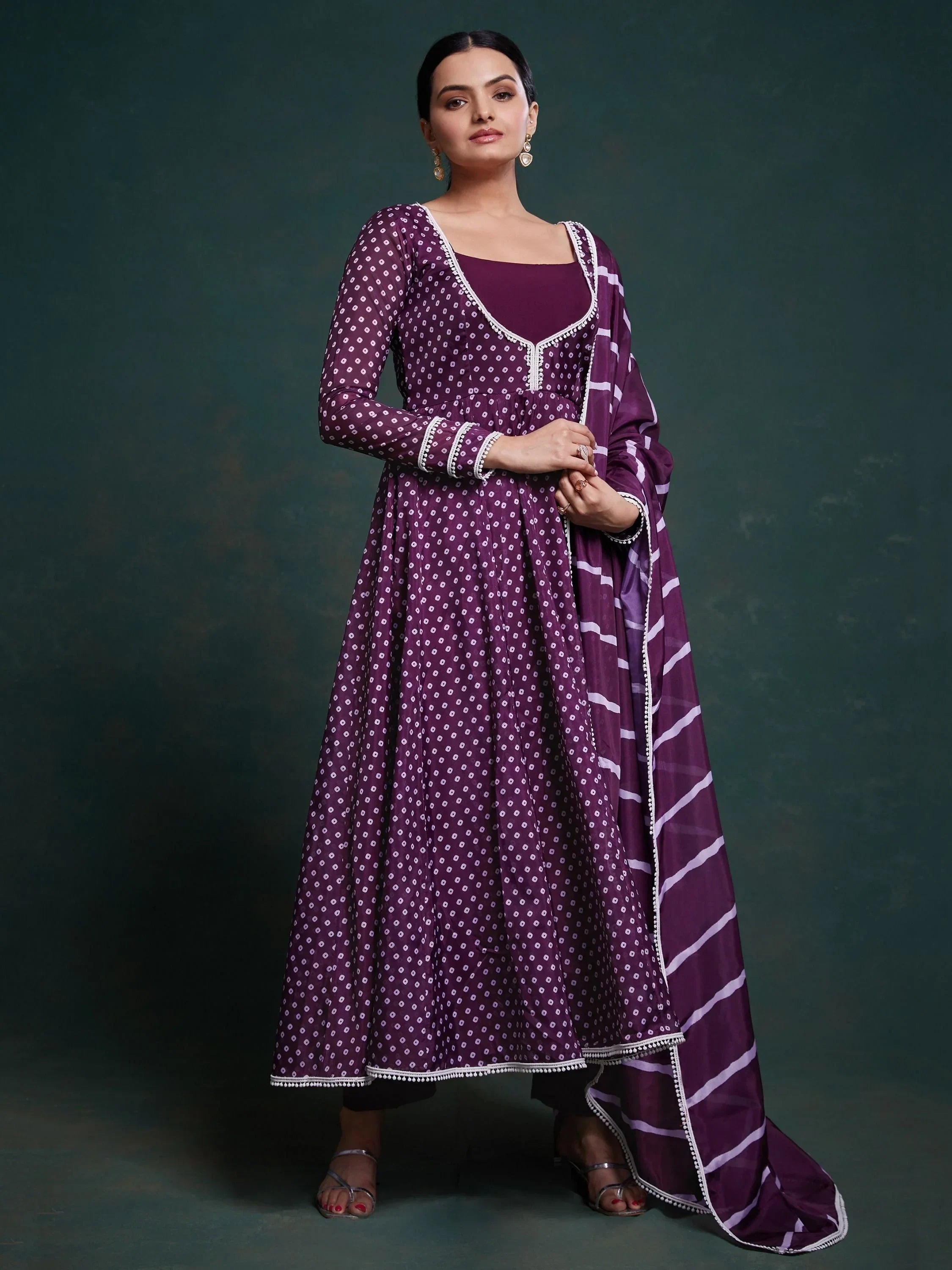 Woman wearing purple Anarkali suit with white bandhani print and matching dupatta