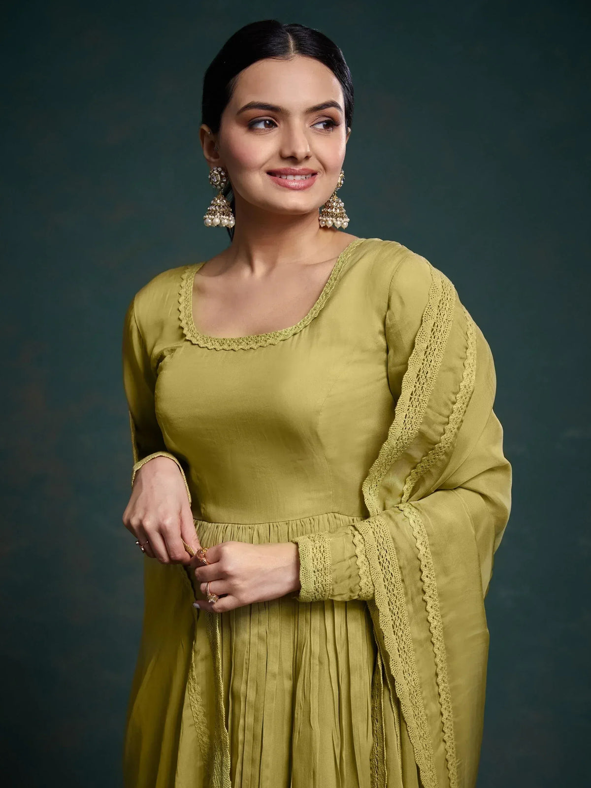 Olive green ethnic anarkali suit with lace detailing and pearl jhumka earrings for women