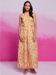 Woman wearing sleeveless yellow floral ethnic gown, standing against pink background, Ethnic Plus