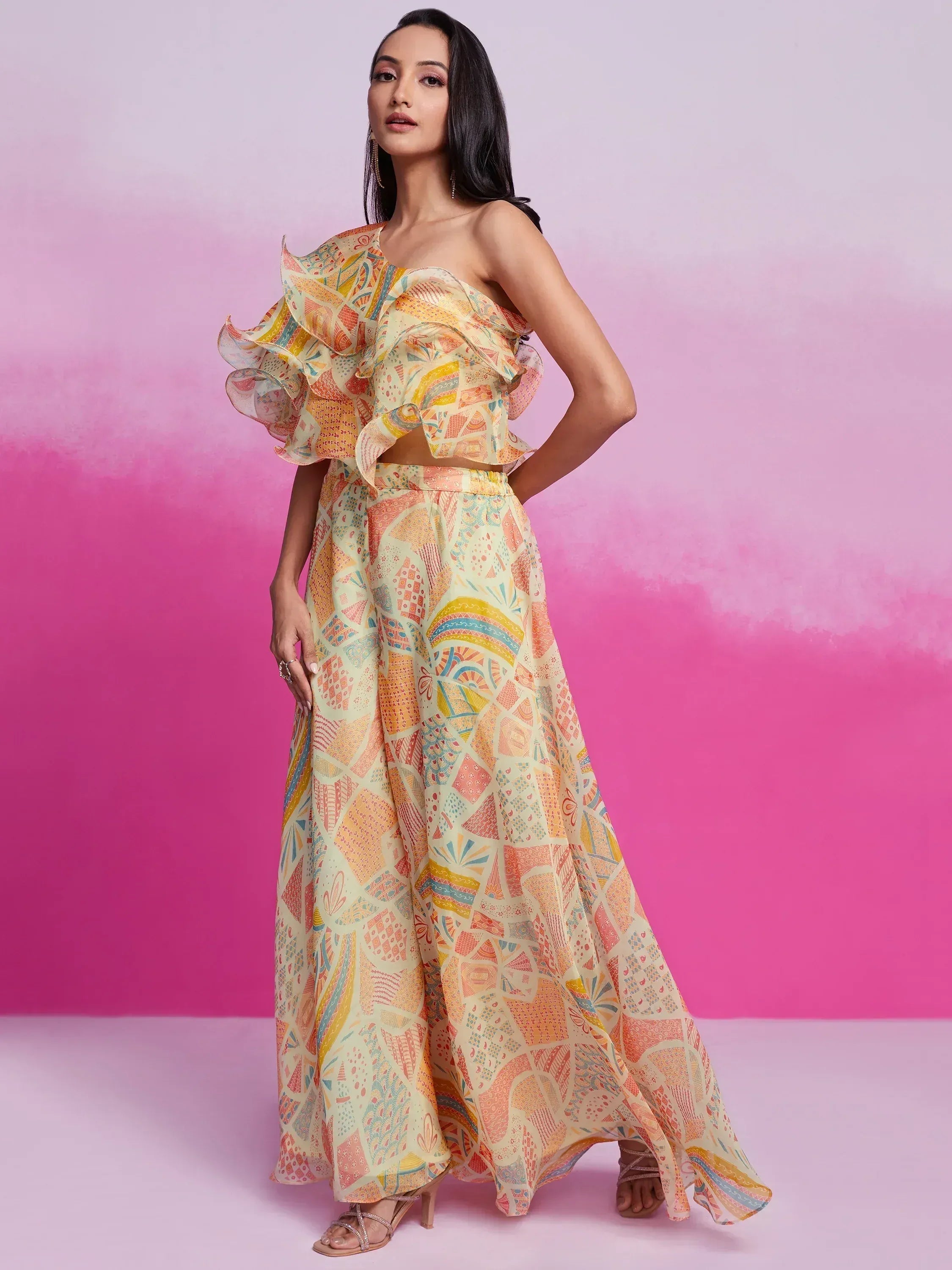 Woman in pastel multi-color printed ethnic co-ord set with ruffle top and flared pants