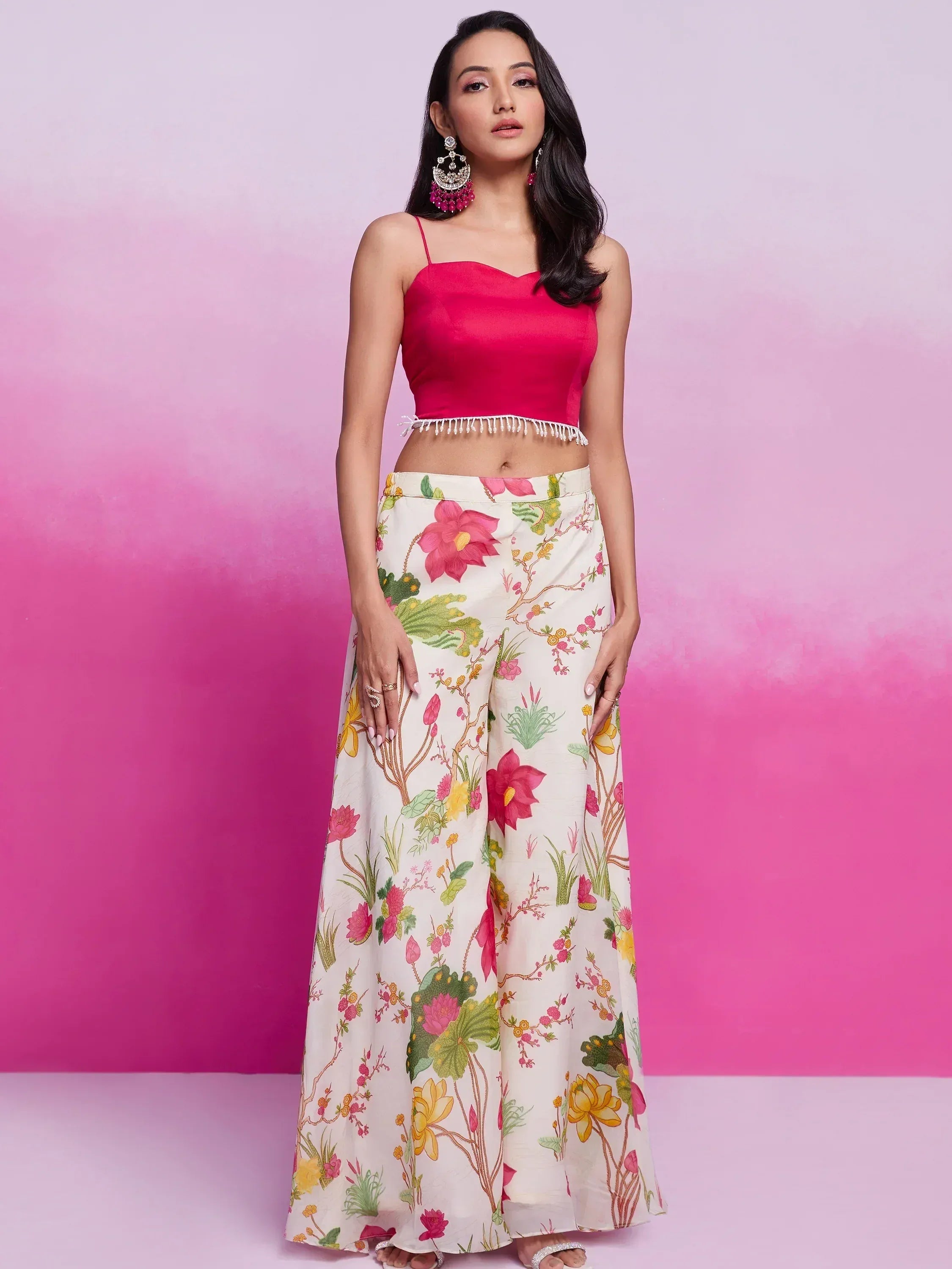 Woman in pink crop top and floral print palazzo pants, ethnic wear outfit
