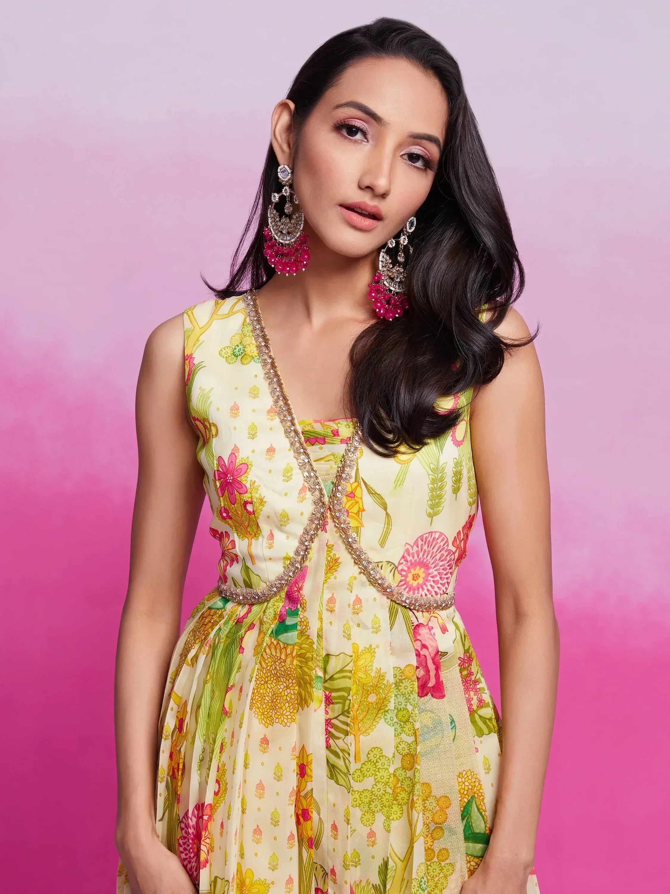 Floral print ethnic gown with embellished neckline, paired with statement earrings for festive occasions.
