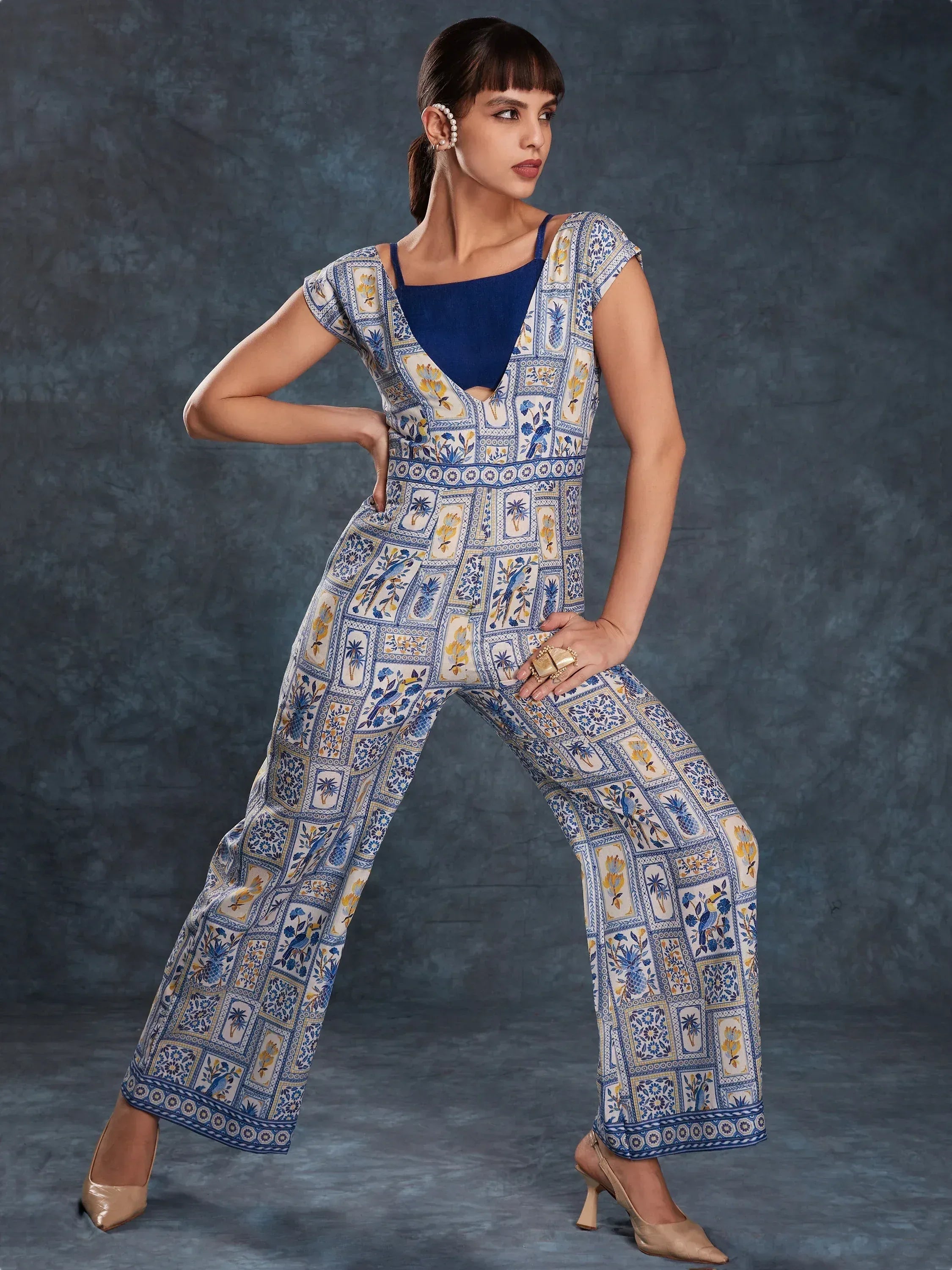 Blue and white printed ethnic jumpsuit with floral and bird motifs, styled with heels for women
