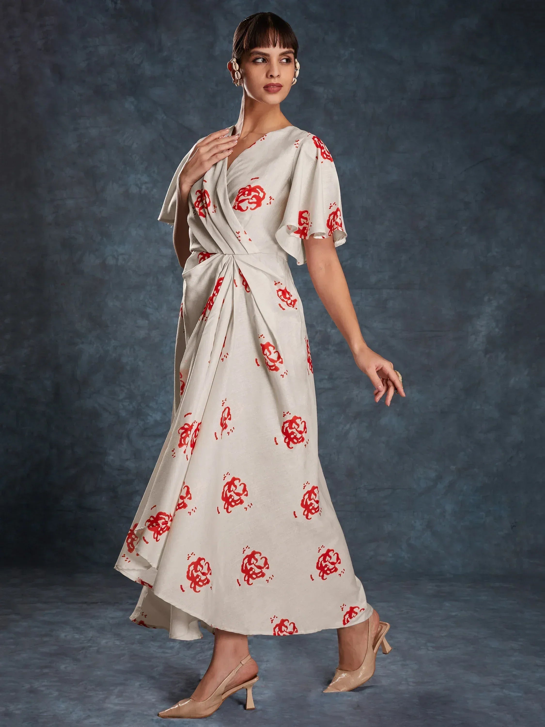 Cream ethnic gown with red floral print, wrap design, and flared sleeves for women