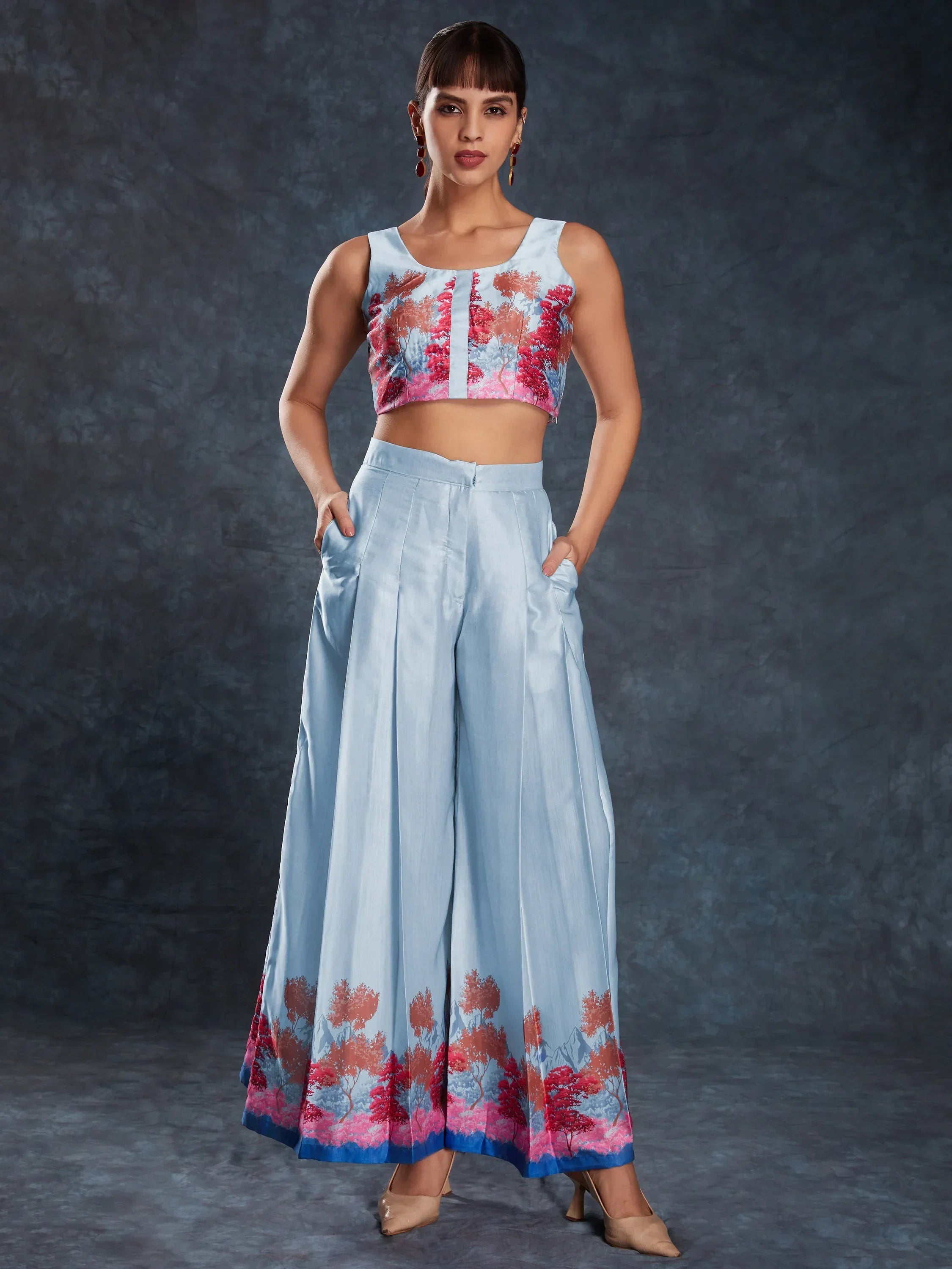 Woman in light blue ethnic crop top and palazzo set with floral print and wide legs
