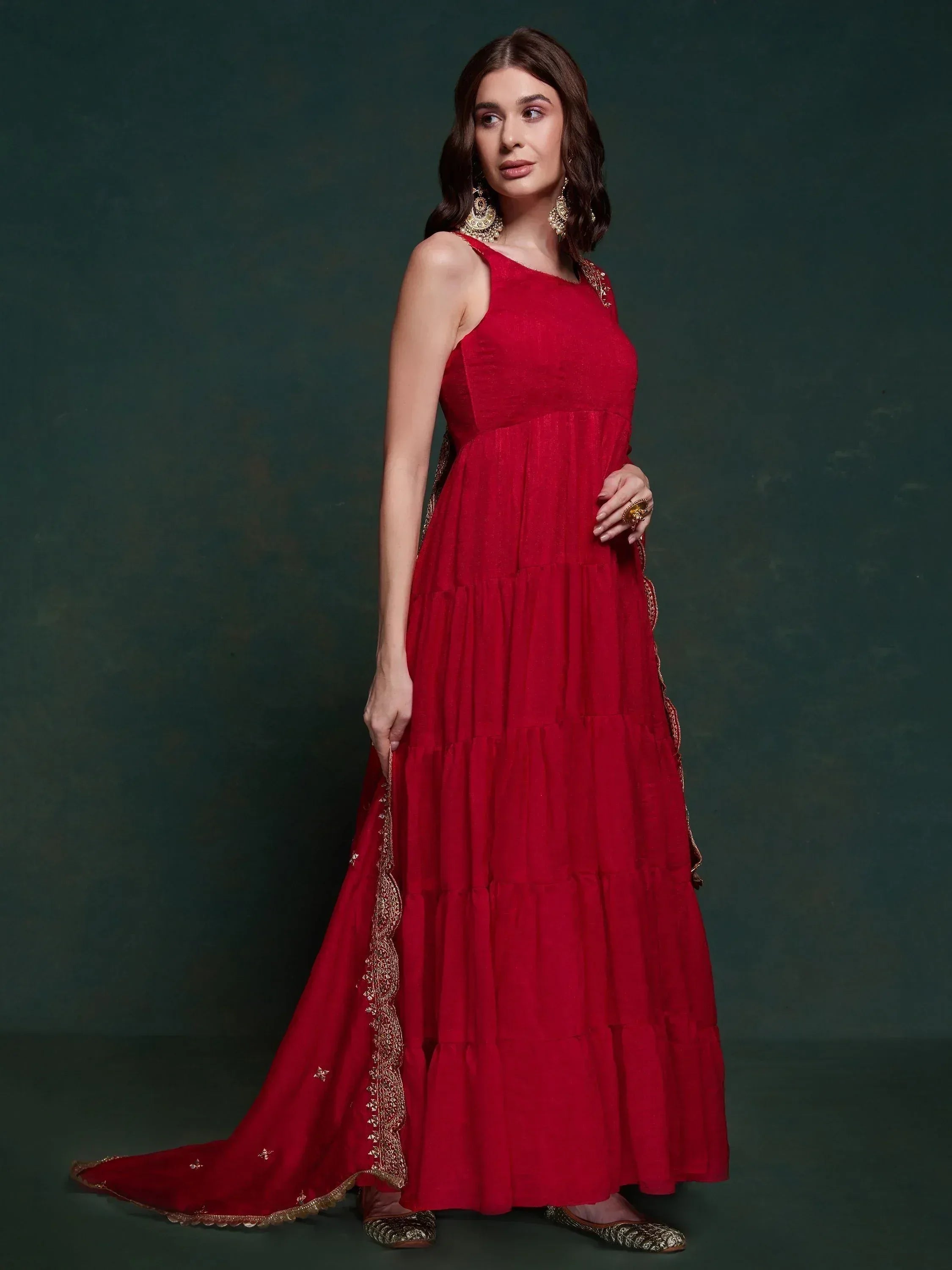 Red ethnic gown with gold embroidery, tiered skirt, and matching dupatta for Indian wear