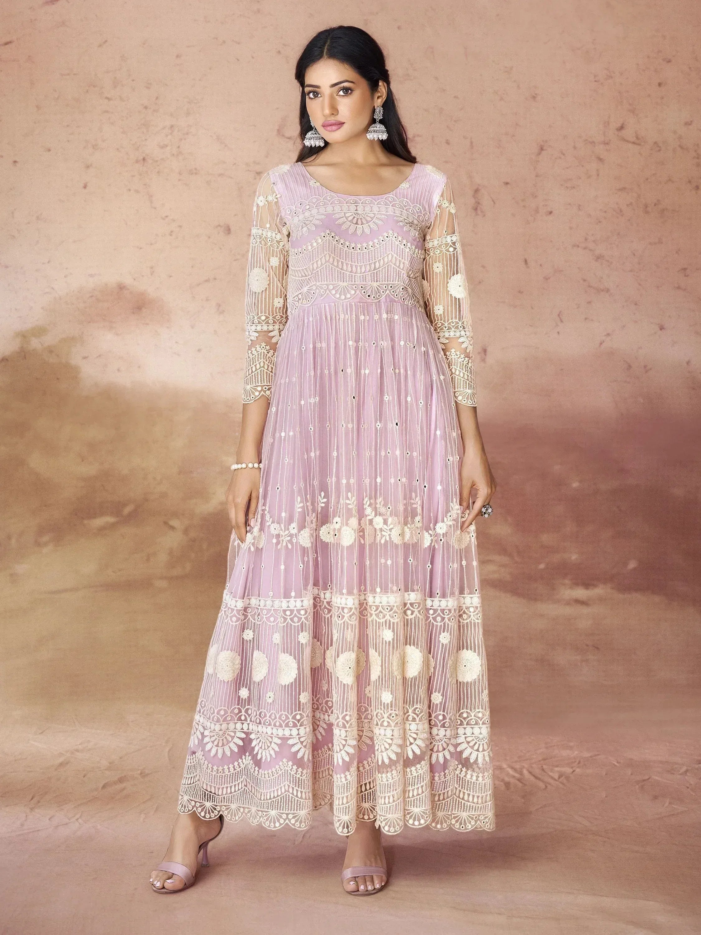 Lavender ethnic gown with intricate white embroidery and sheer sleeves, perfect for Indian festive occasions.