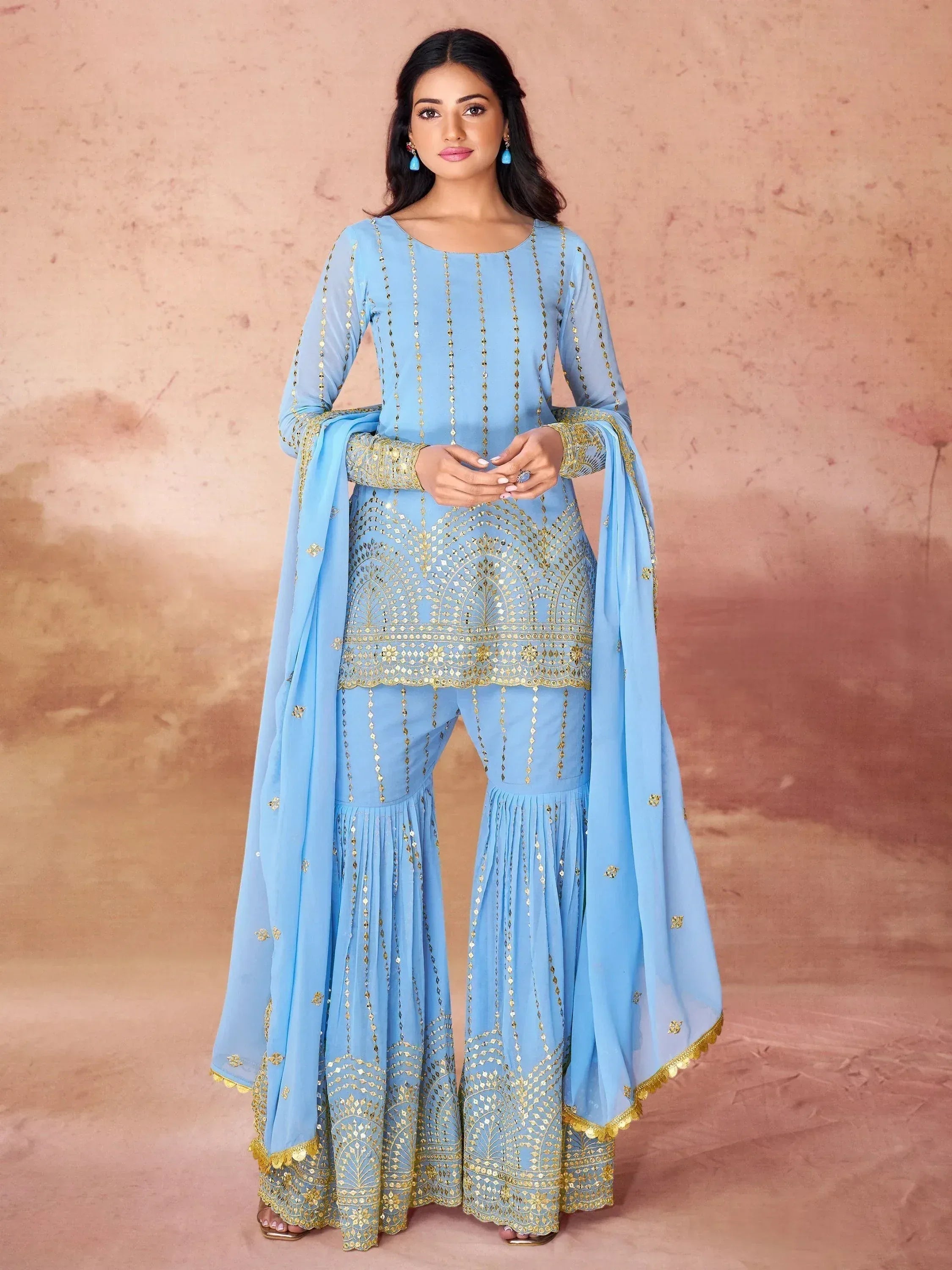 Light blue ethnic salwar kameez with gold embroidery and flared pants, perfect for festive occasions.