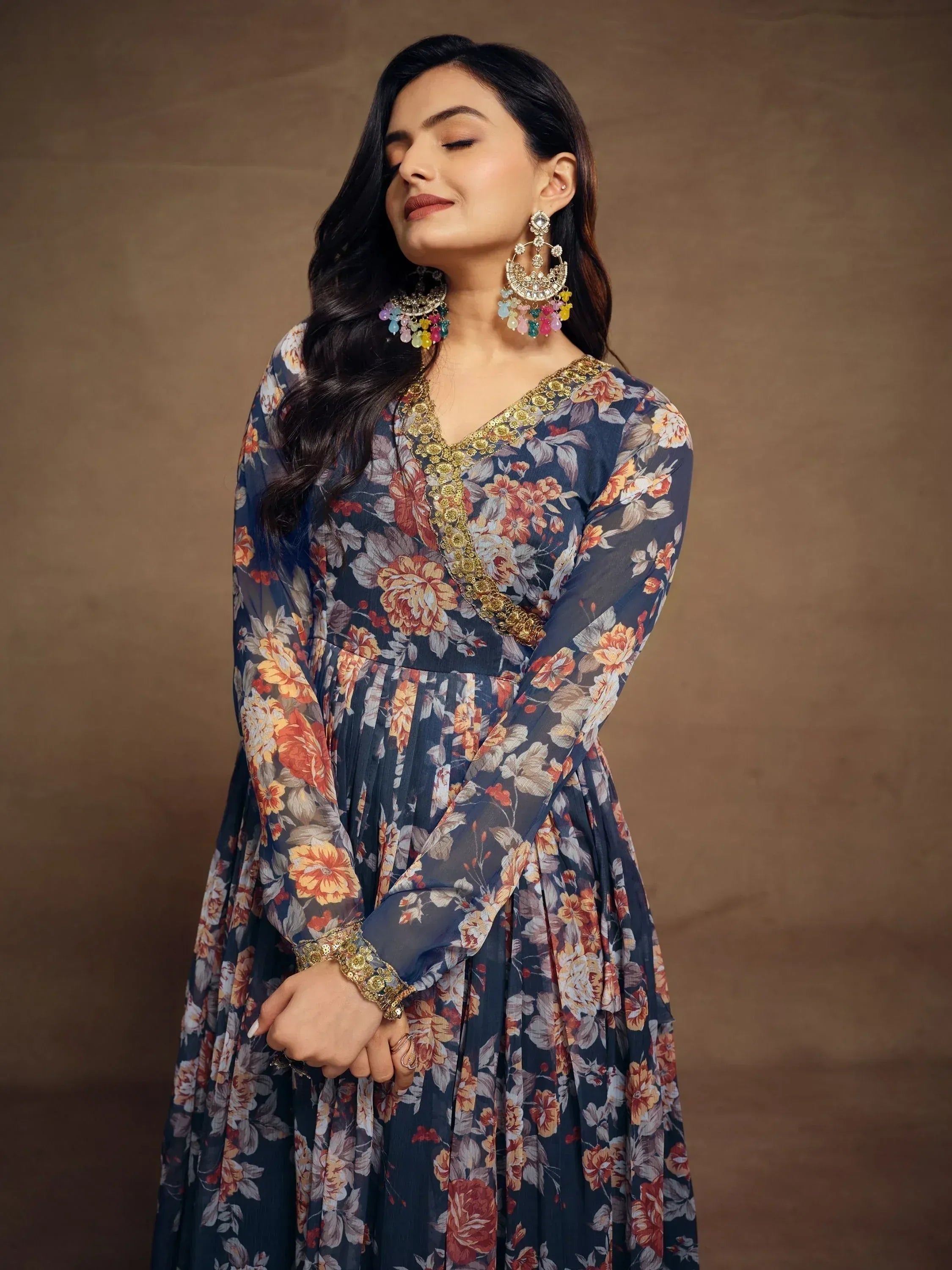 Floral print ethnic gown with gold embroidery and statement earrings for Indian women
