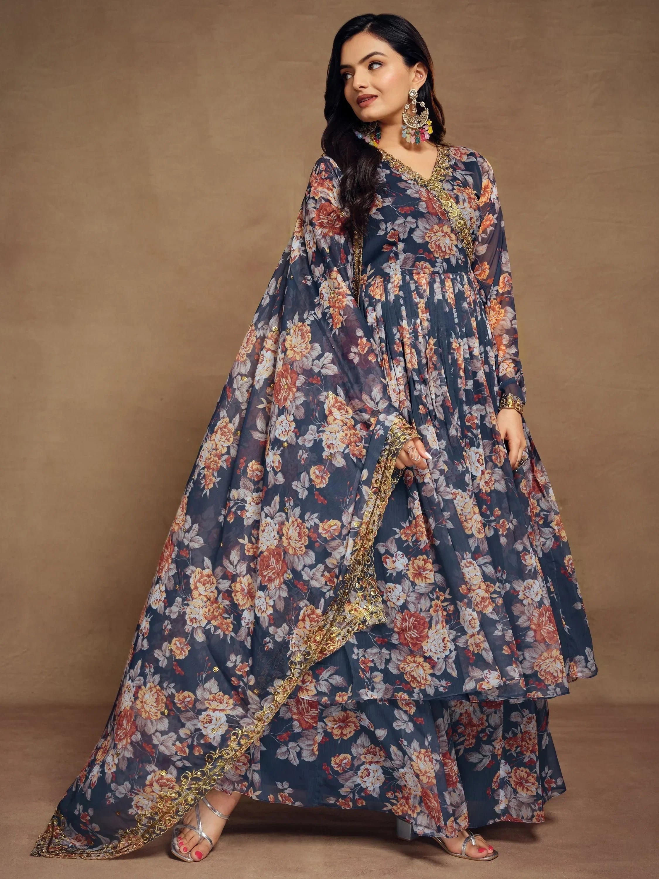 Woman in navy blue floral printed ethnic gown with dupatta and golden border