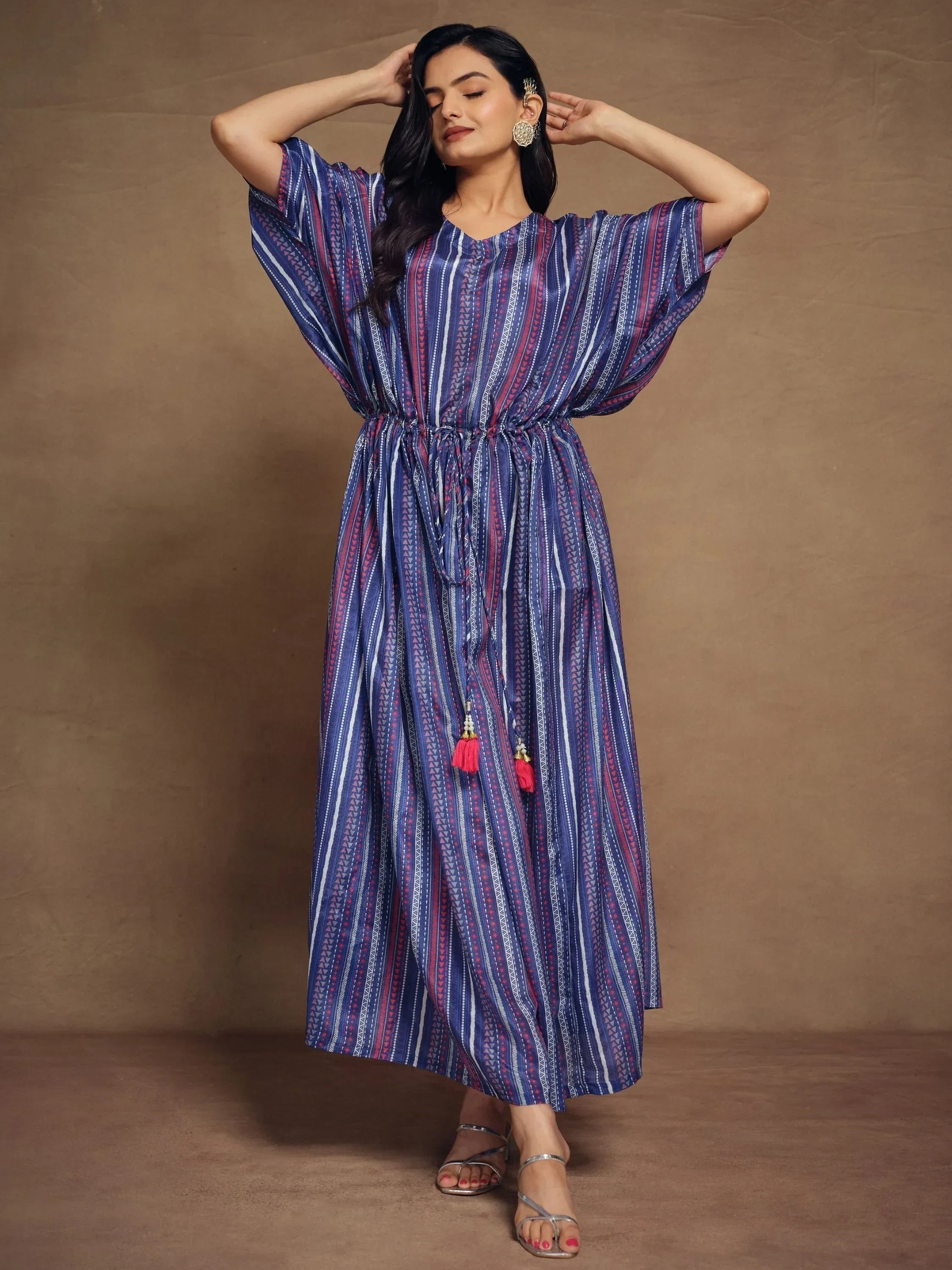 Woman in blue and purple striped kaftan dress with drawstring waist and tassels, ethnic style