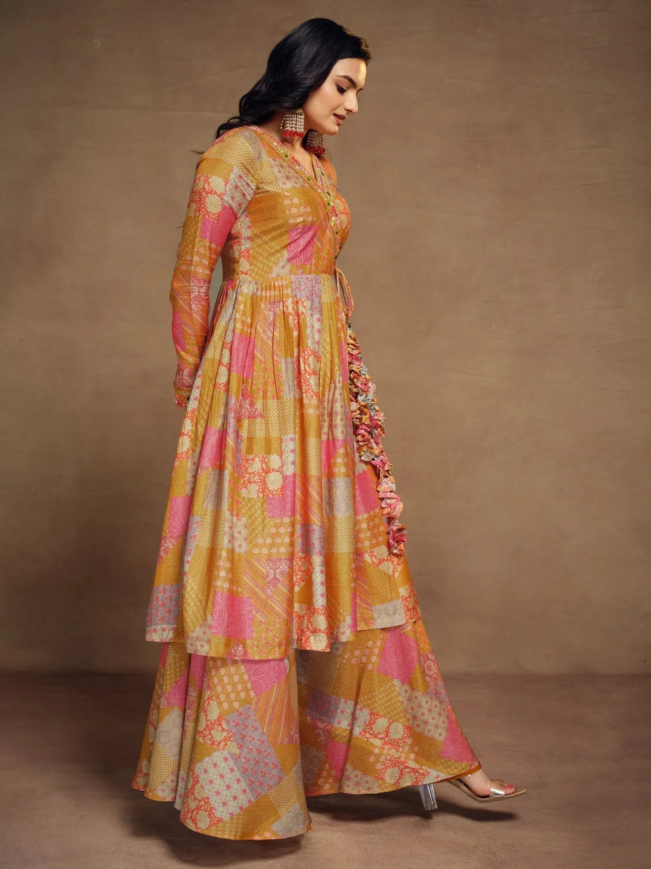 Vibrant patchwork ethnic gown with floral ruffles and long sleeves for festive occasions