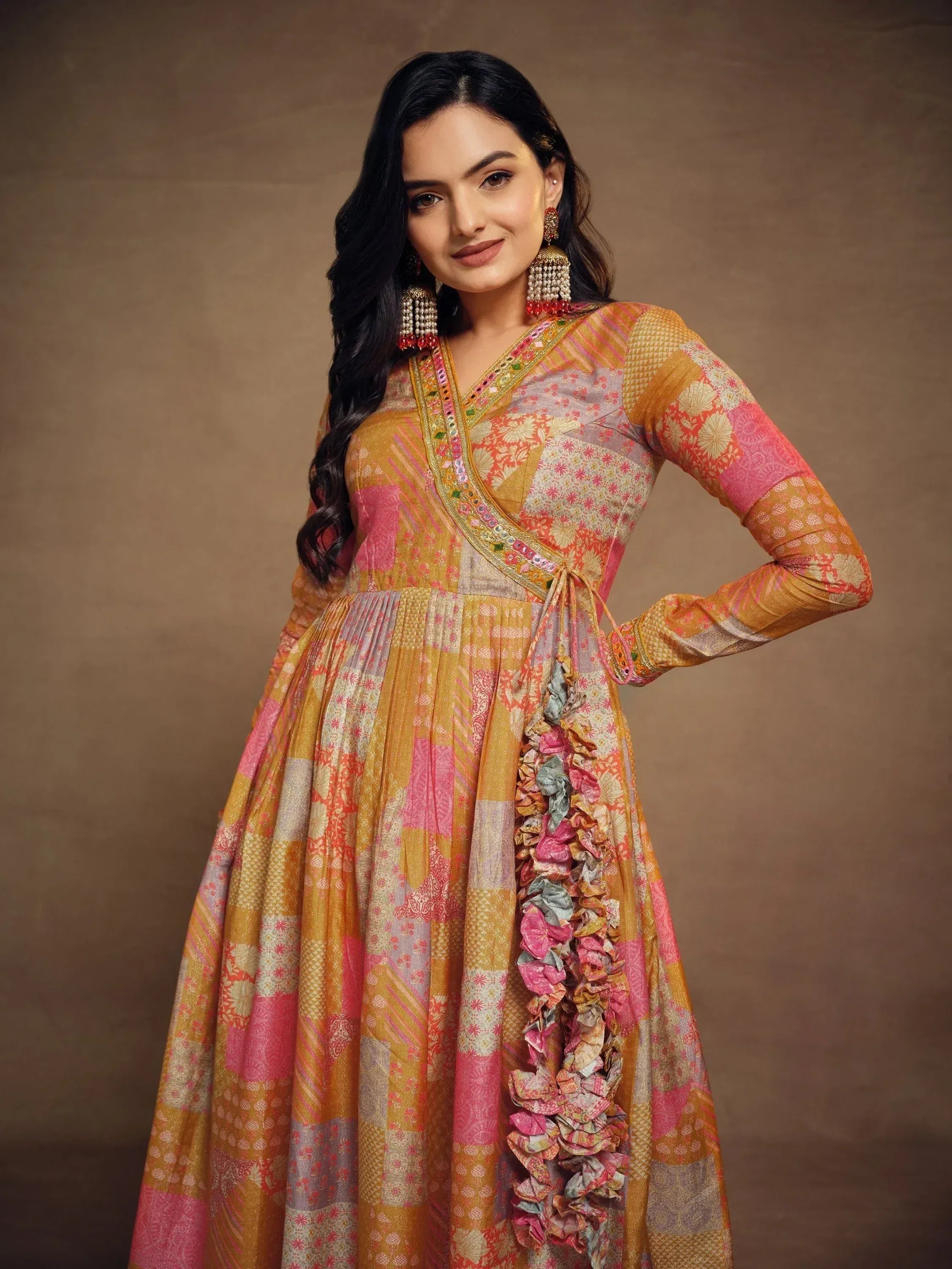 Vibrant ethnic gown with floral patterns and ruffled detailing, perfect for festive occasions.
