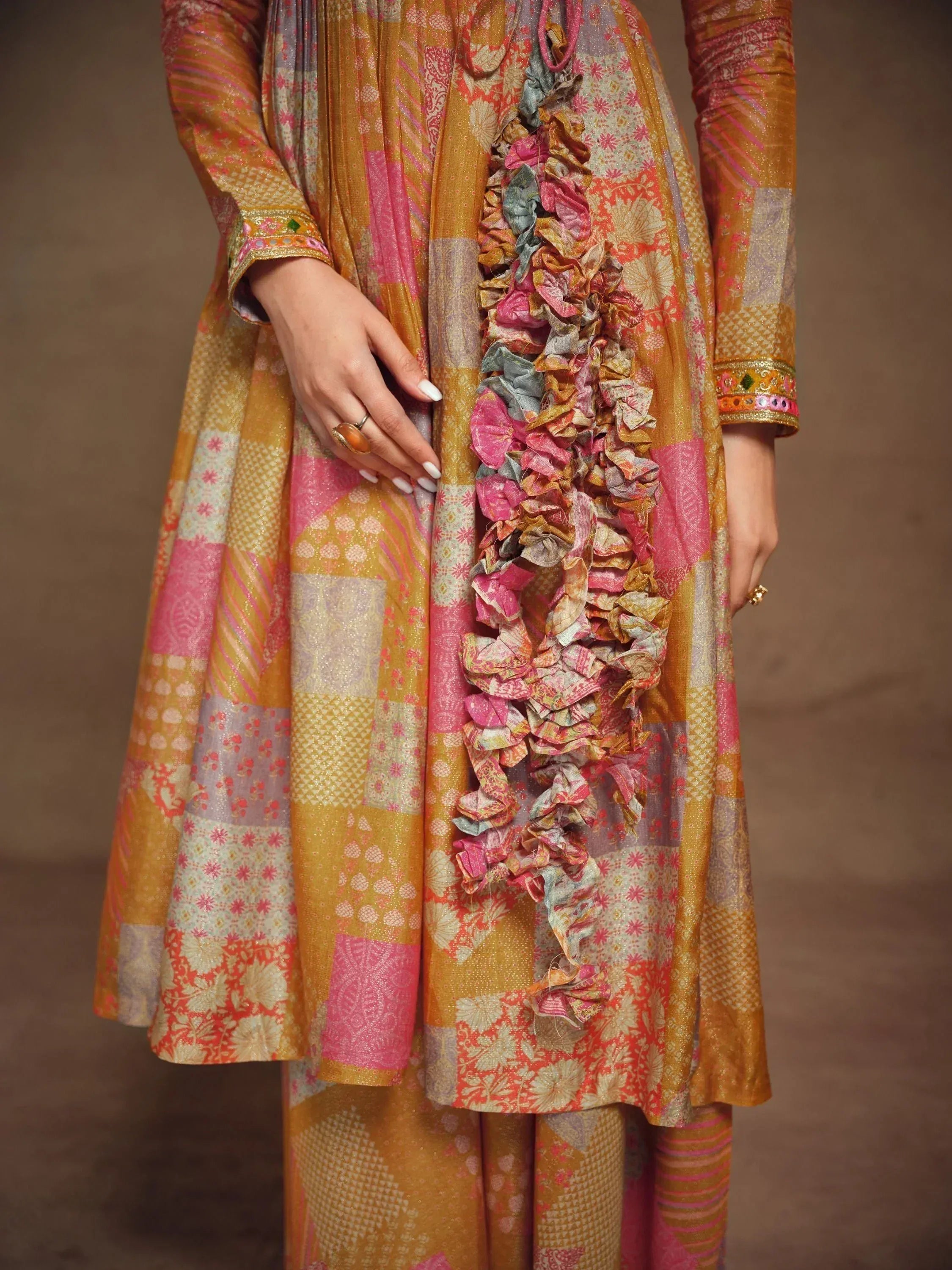 Vibrant patchwork salwar kameez with ruffled detailing, perfect for Indian ethnic wear