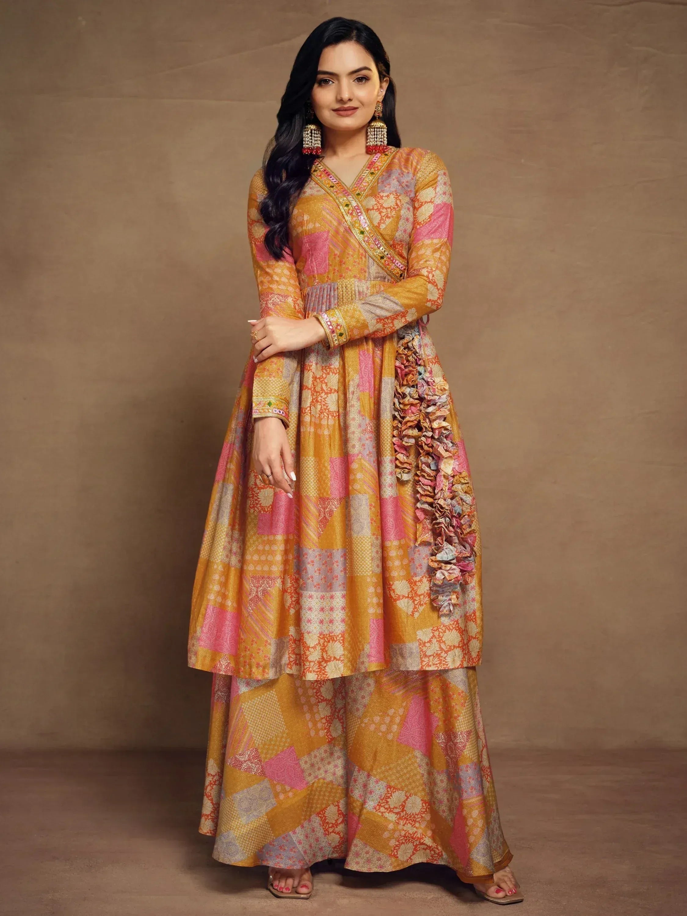 Woman in vibrant patchwork Indian anarkali suit with ruffle detailing, perfect for ethnic occasions