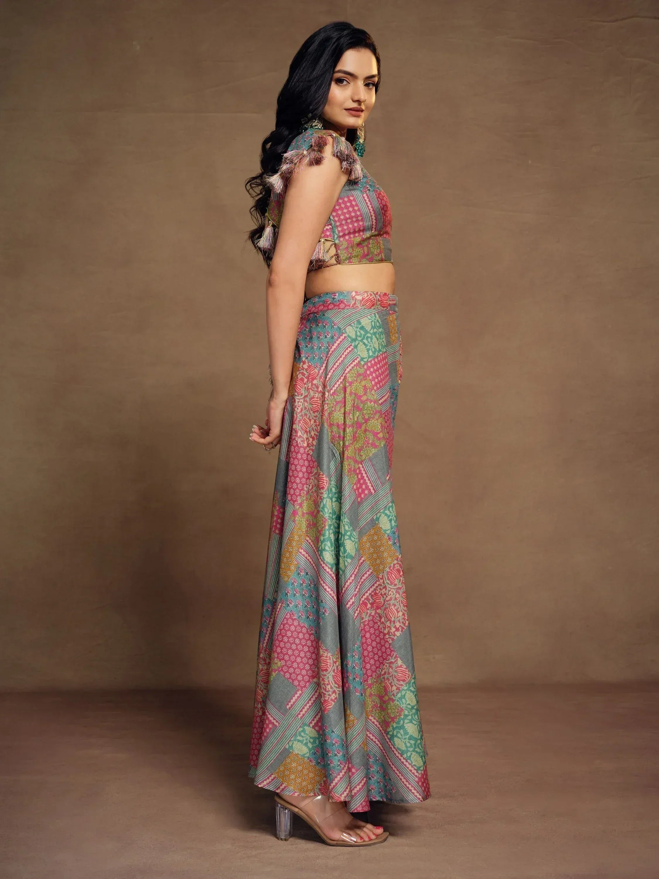 Woman in colorful printed ethnic lehenga choli with tassel details, perfect for festive occasions