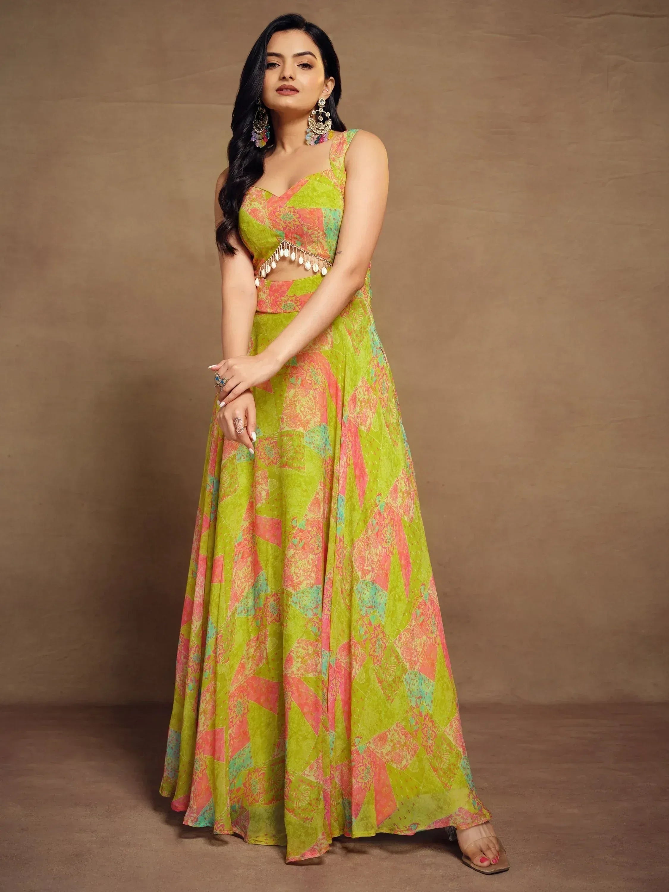 Vibrant green and pink printed ethnic gown with tassel detailing, perfect for festive occasions.
