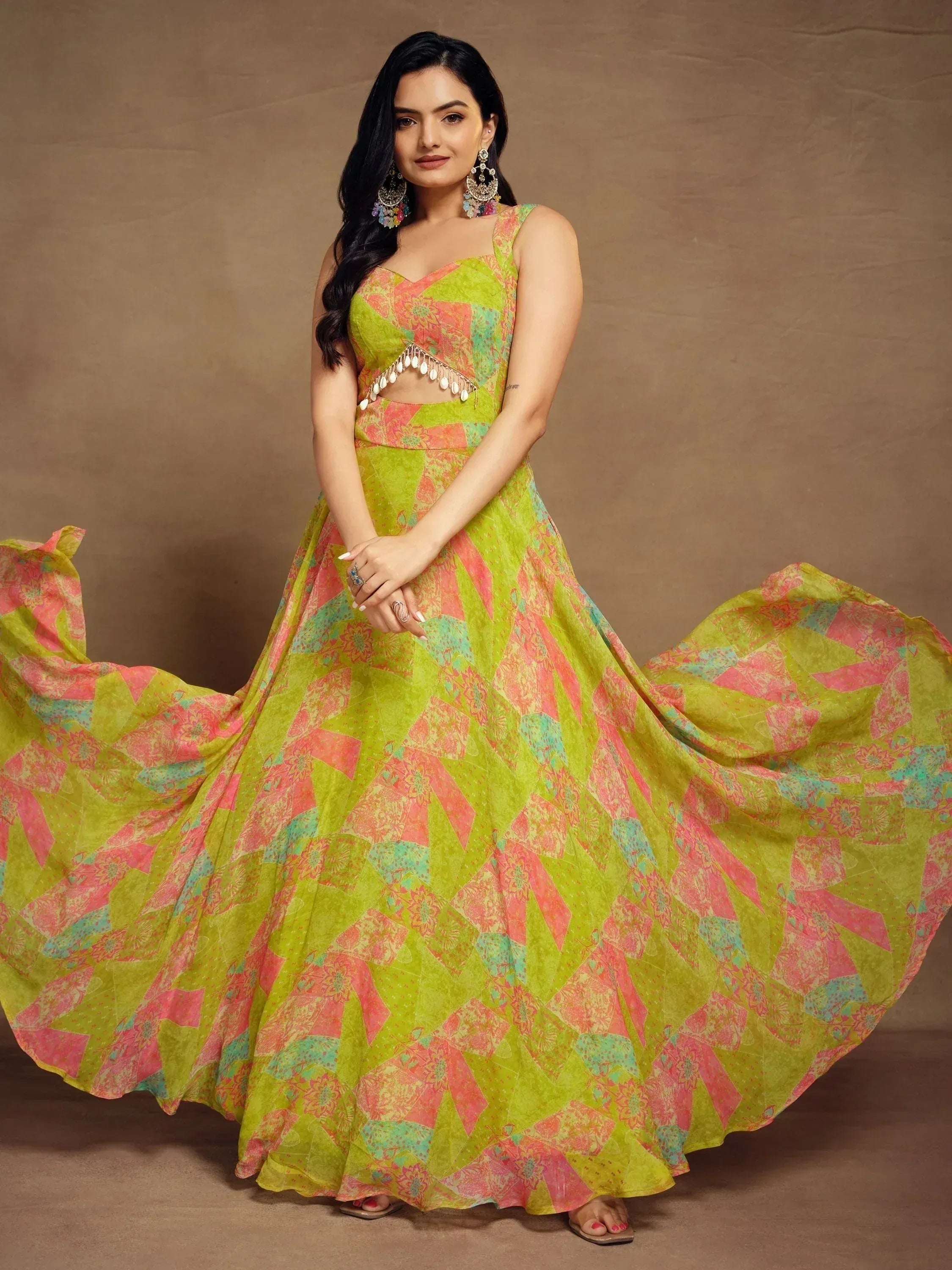 Vibrant green and pink printed lehenga choli with floral patterns and tassel detailing, perfect for festive occasions.