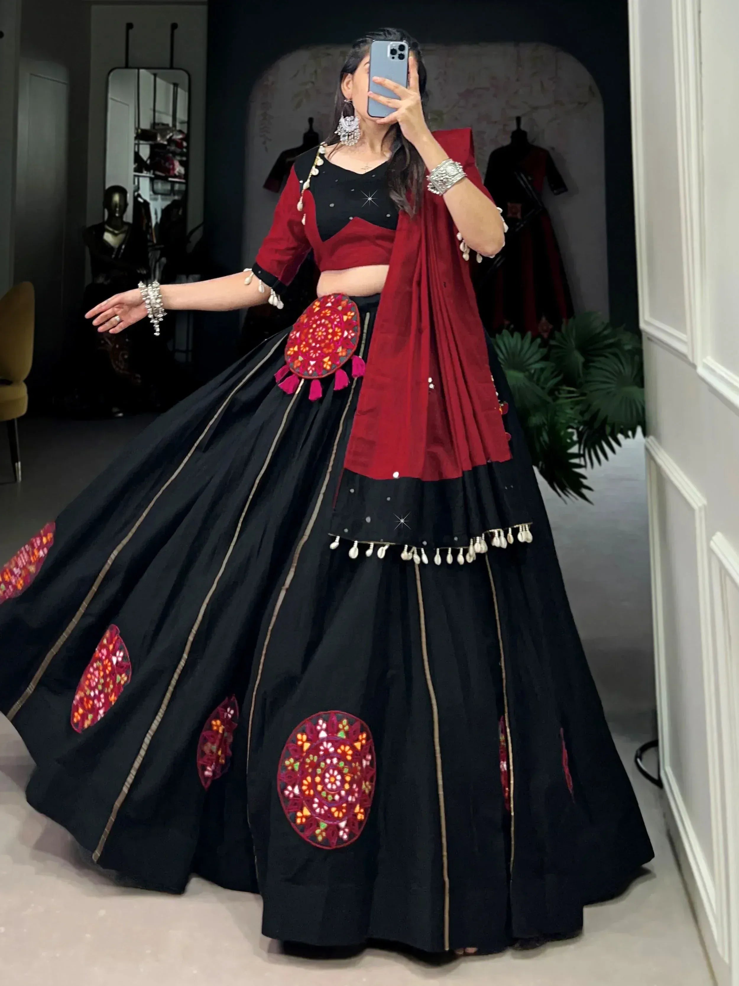 Black and red ethnic lehenga choli with mirror work, perfect for Indian weddings and festive occasions.